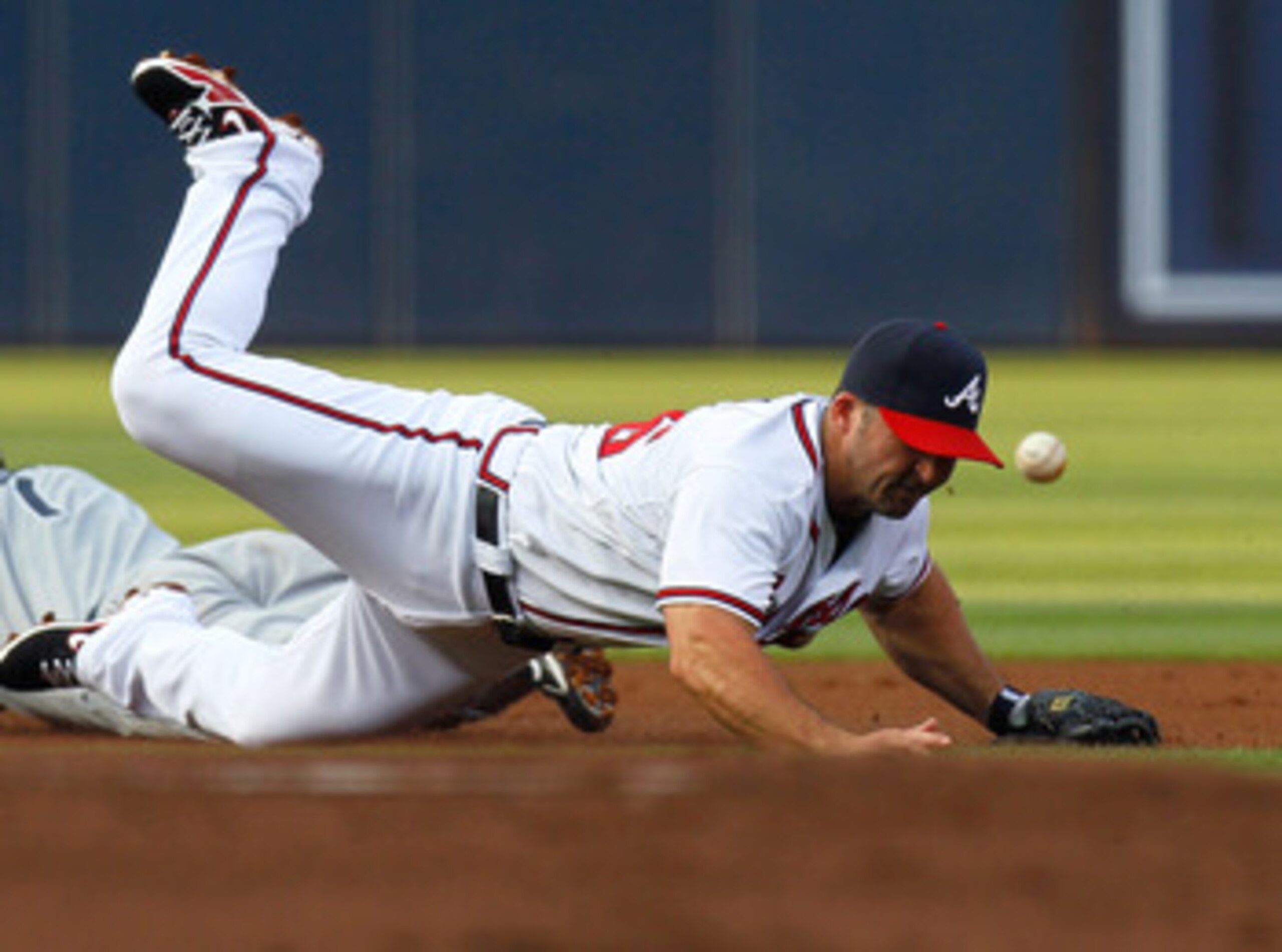 ATLANTA, GA - JUNE 01:  Chase Headley #7 of the San Diego Padres steals second base under Dan Uggla #26 of the Atlanta Braves in the first inning at Turner Field on June 1, 2011 in Atlanta, Georgia.  (Photo by Kevin C. Cox/Getty Images)