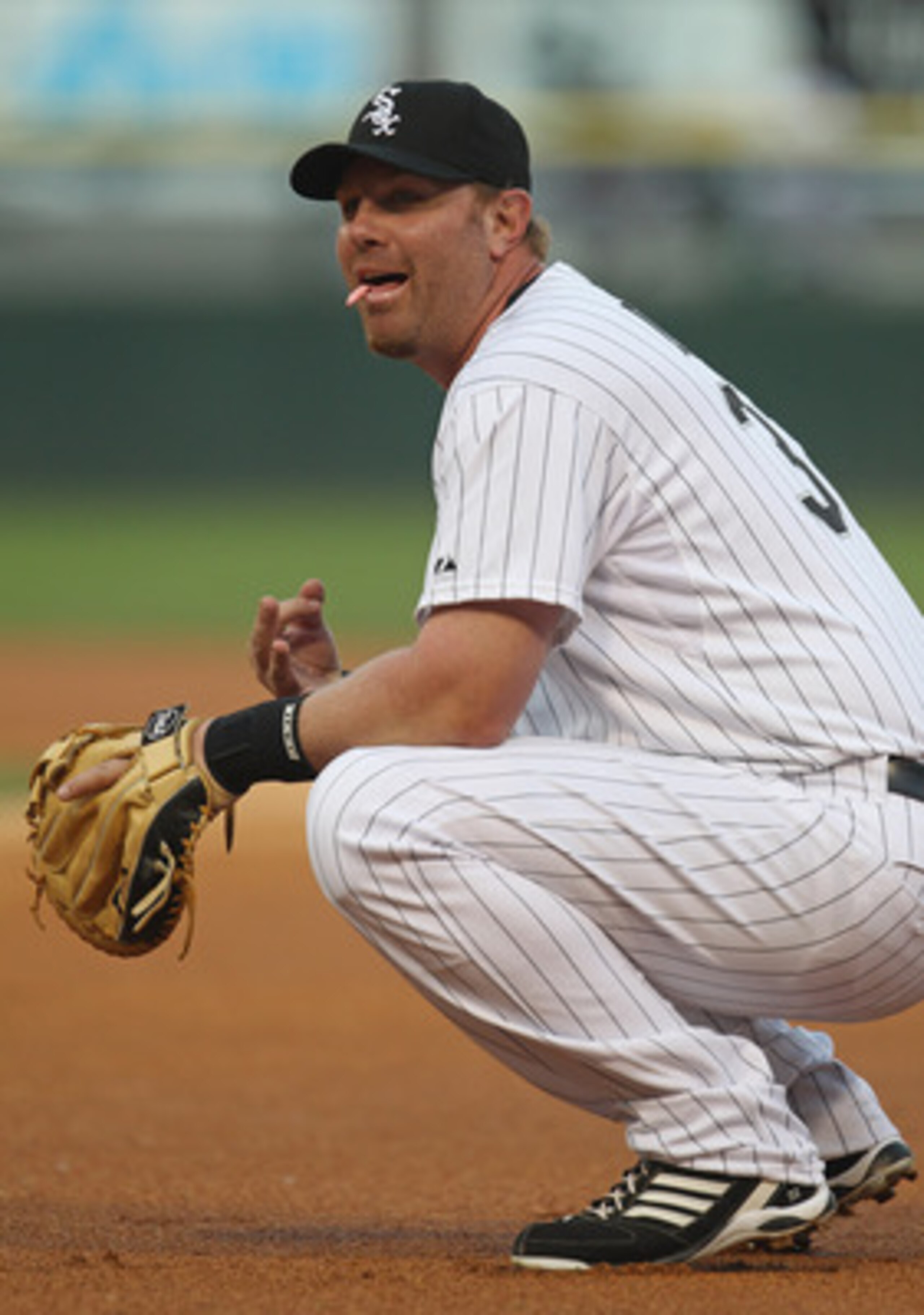 CHICAGO, IL - JUNE 06:  Adam Dunn #32 of the Chicago White Sox talks with members of the Seattle Mariners before the start of a game at U.S. Cellular Field on June 6, 2011 in Chicago, Illinois. The White Sox defeated the Mariners 3-1.  (Photo by Jonathan