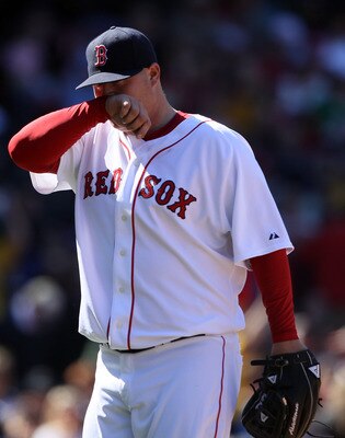 BOSTON, MA - MAY 01: Bobby Jenks #52 of the Boston Red Sox walks off the field after walking in two runs in the sixth inning against the Seattle Mariners on May 1, 2011 at Fenway Park in Boston, Massachusetts.  (Photo by Elsa/Getty Images)