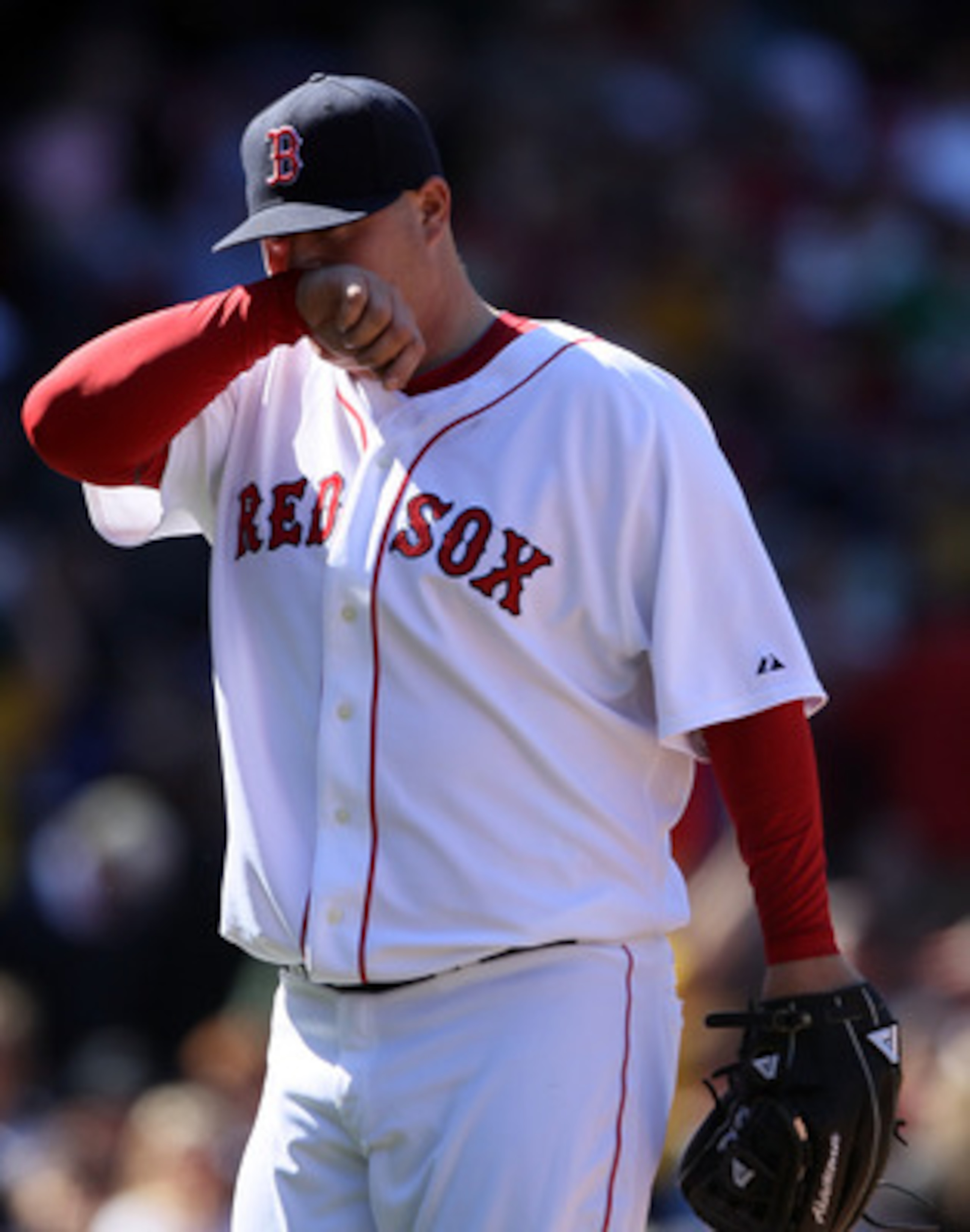 BOSTON, MA - MAY 01: Bobby Jenks #52 of the Boston Red Sox walks off the field after walking in two runs in the sixth inning against the Seattle Mariners on May 1, 2011 at Fenway Park in Boston, Massachusetts.  (Photo by Elsa/Getty Images)