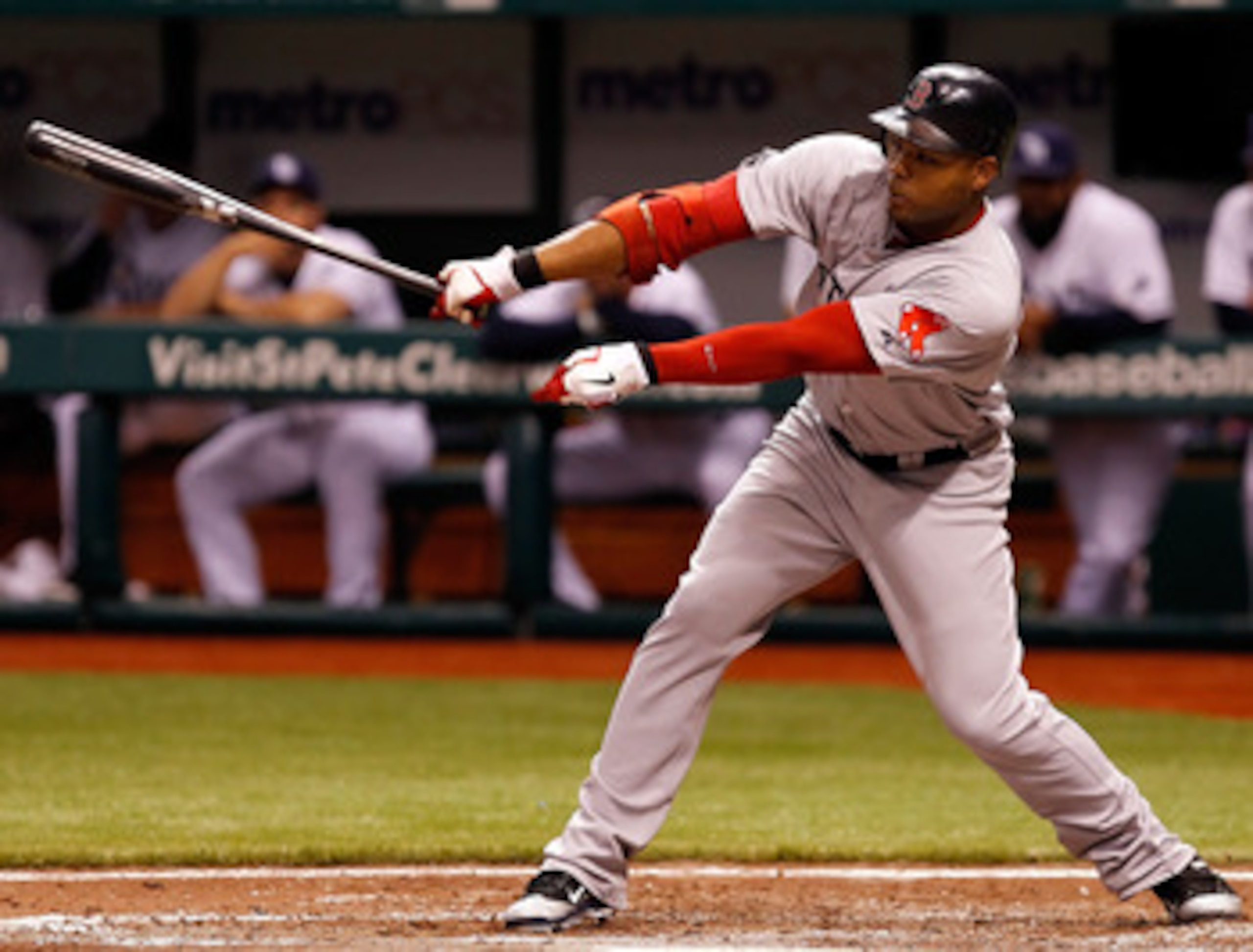 ST PETERSBURG, FL - JUNE 14:  Outfielder Carl Crawford #13 of the Boston Red Sox fouls off a pitch against the Tampa Bay Rays during the game at Tropicana Field on June 14, 2011 in St. Petersburg, Florida.  (Photo by J. Meric/Getty Images)