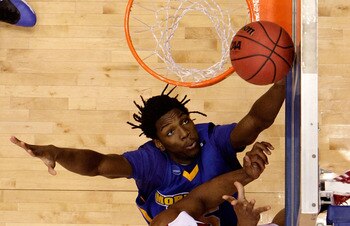 DAYTON, OH - MARCH 20: Samardo Samuels #24 of the Louisville Cardinals drives to the hoop against Kenneth Faried #35 of the Morehead State Eagles during the first round of the NCAA Division I Men's Basketball Tournament at the University of Dayton Arena o
