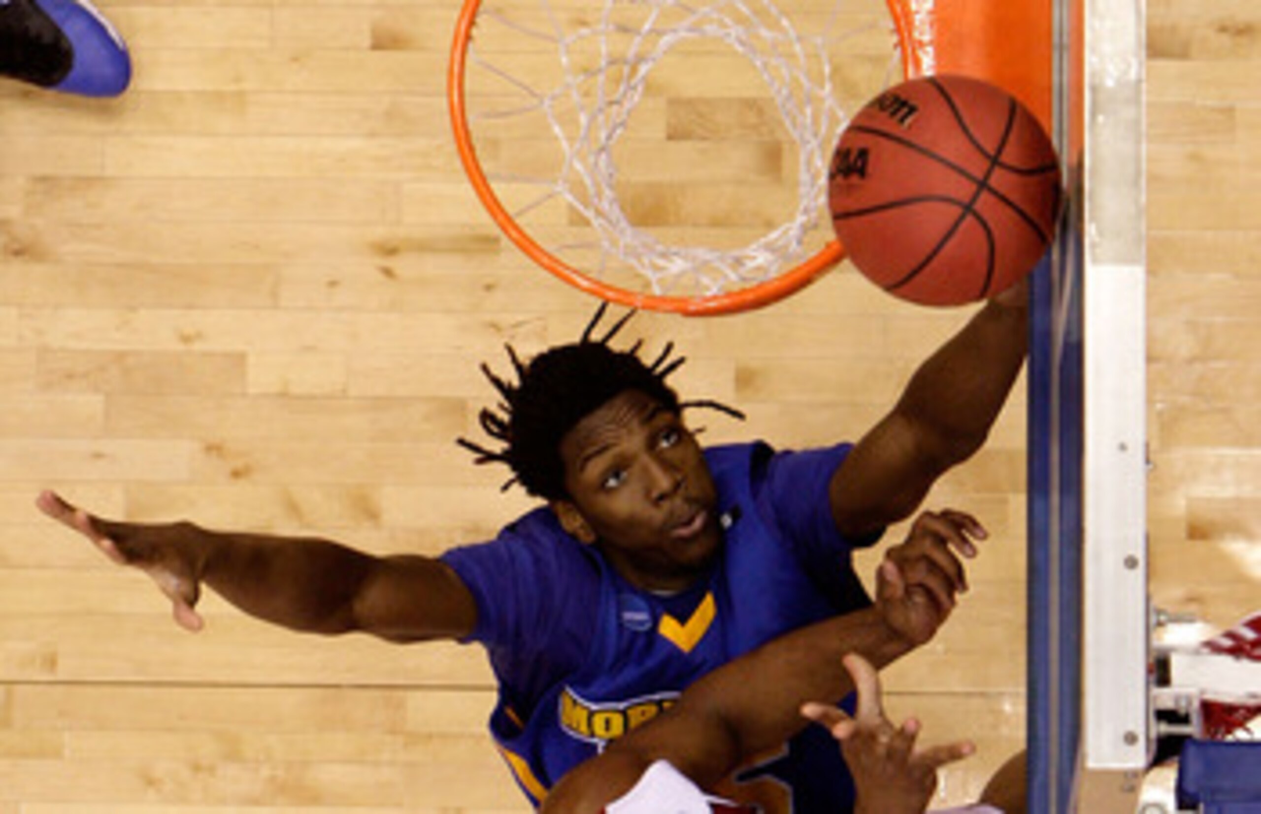 DAYTON, OH - MARCH 20: Samardo Samuels #24 of the Louisville Cardinals drives to the hoop against Kenneth Faried #35 of the Morehead State Eagles during the first round of the NCAA Division I Men's Basketball Tournament at the University of Dayton Arena o