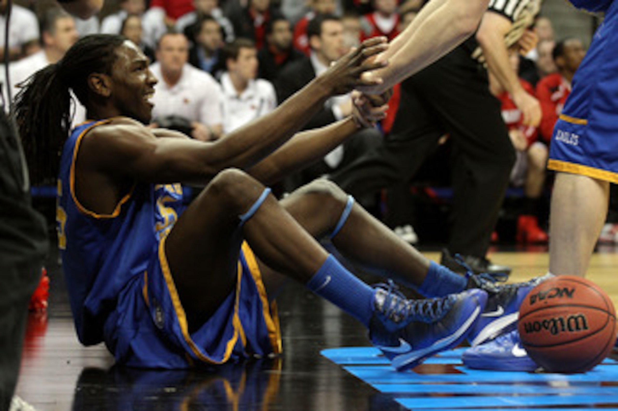 DENVER, CO - MARCH 17:  Kenneth Faried #35 of the Morehead State Eagles is helped up after drawing a foul against the Louisville Cardinals in the second round of the 2011 NCAA men's basketball tournament at Pepsi Center on March 17, 2011 in Denver, Colora