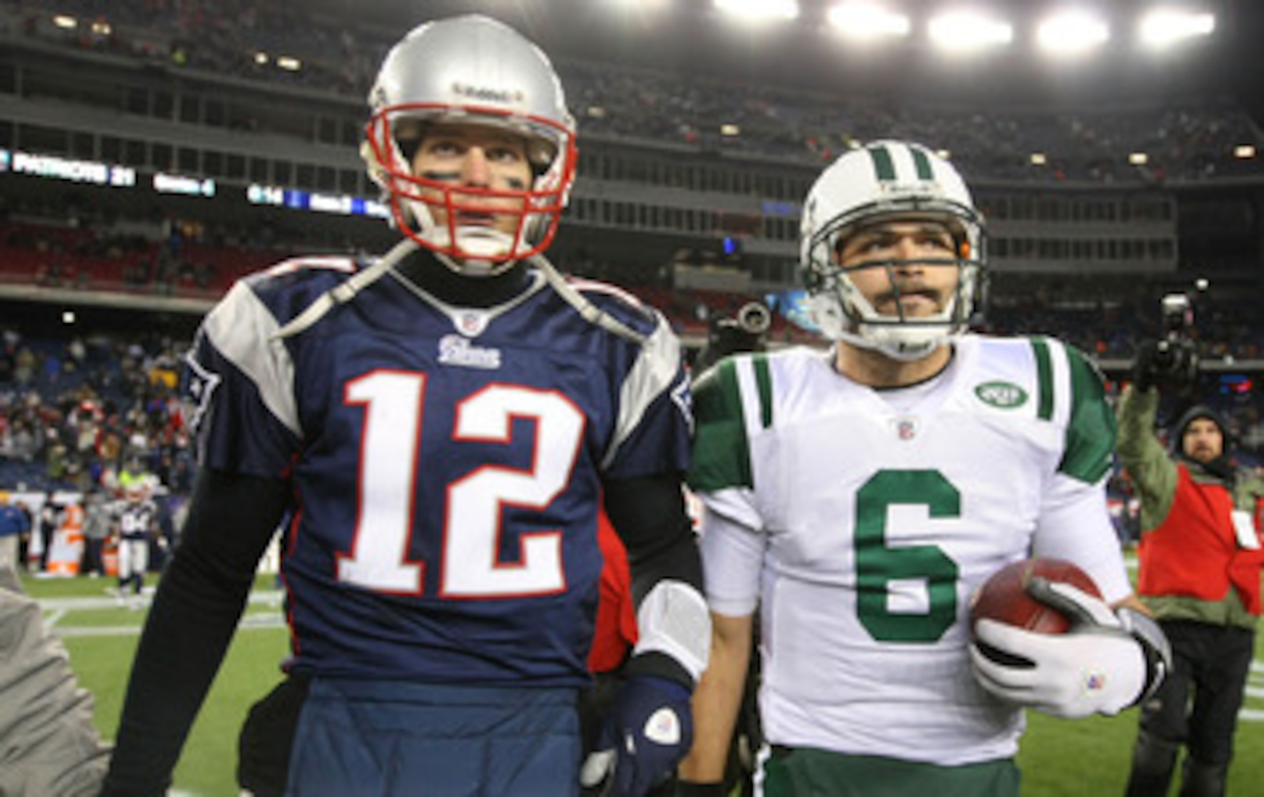 FOXBORO, MA - JANUARY 16:  Tom Brady #12 of the New England Patriots and Mark Sanchez #6 of the New York Jets walk off the field after the Jets defeated the Patriots 28 to 21 their 2011 AFC divisional playoff game at Gillette Stadium on January 16, 2011 i
