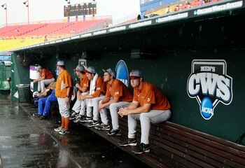 OMAHA, NE - JUNE 23:  (R-L) Cameron Rupp #3, Cole Green #24, Austin Wood #44 of the Texas Longhorns sit in the dugout during a rain delay before taking on the Louisiana State University Tigers during Game 2 of the 2009 NCAA College World Series at Rosenbl