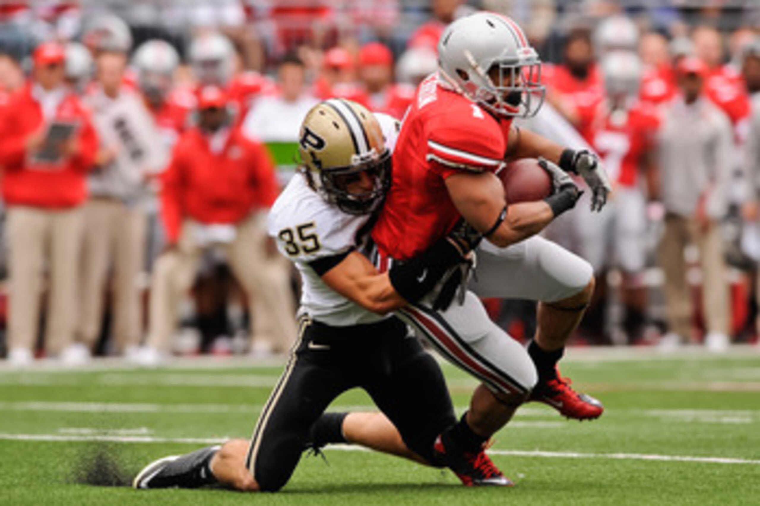COLUMBUS, OH - OCTOBER 23: Logan Link #35 of the Purdue Boilermakers tackles Dan Herron #1 of the Ohio State Buckeyes at Ohio Stadium on October 23, 2010 in Columbus, Ohio. (Photo by Jamie Sabau/Getty Images) COLUMBUS, OH - OCTOBER 23: Logan Link #35 of the Purdue Boilermakers tackles Dan Herron #1 of the Ohio State Buckeyes at Ohio Stadium on October 23, 2010 in Columbus, Ohio. (Photo by Jamie Sabau/Getty Images)