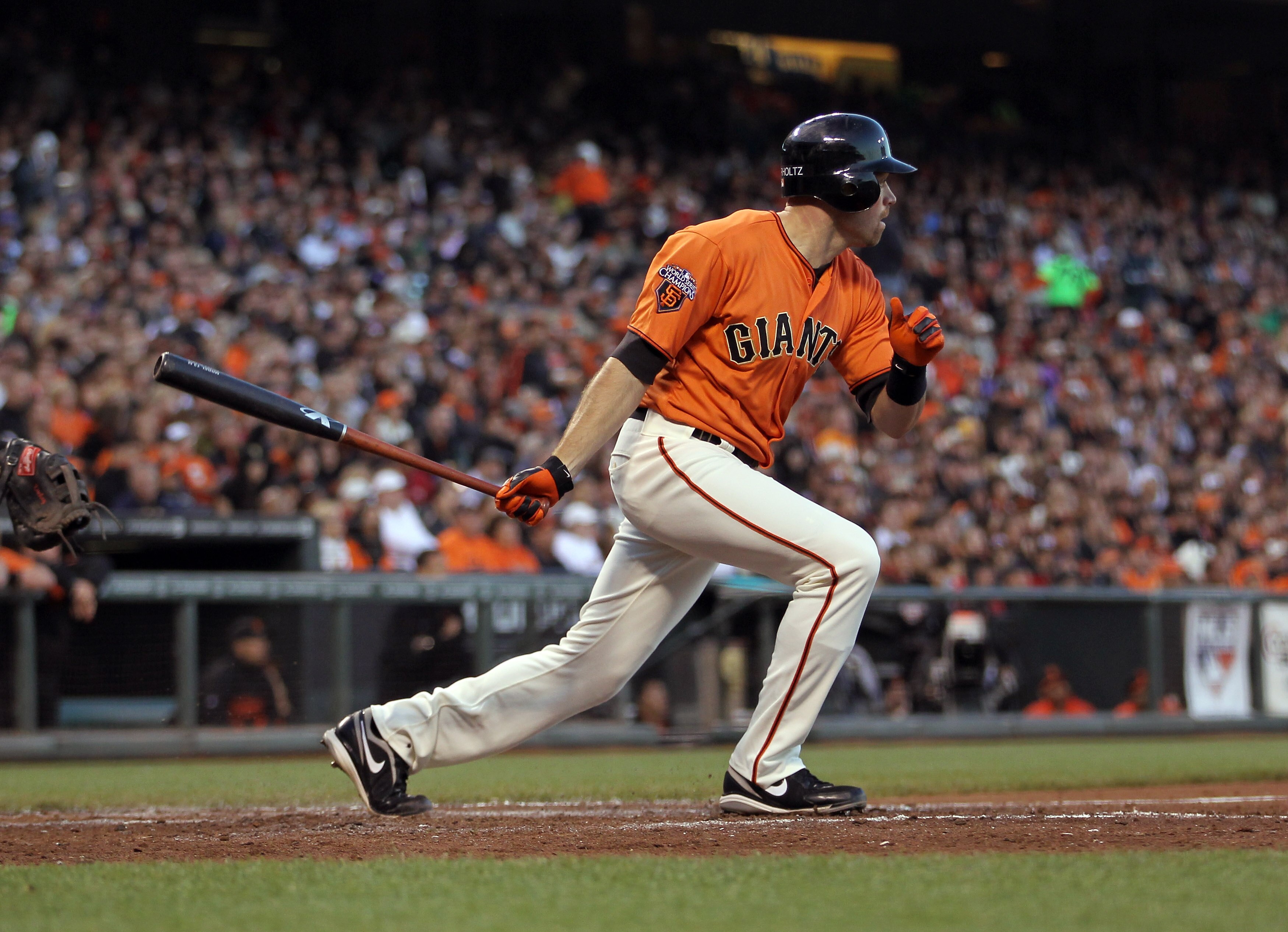 SAN FRANCISCO, CA - JULY 08:  Nate Schierholtz #12 of the San Francisco Giants hits a sacrifice fly that scored Pablo Sandoval #48 in the fourth inning against the New York Mets at AT&T Park on July 8, 2011 in San Francisco, California.  (Photo by Ezra Sh