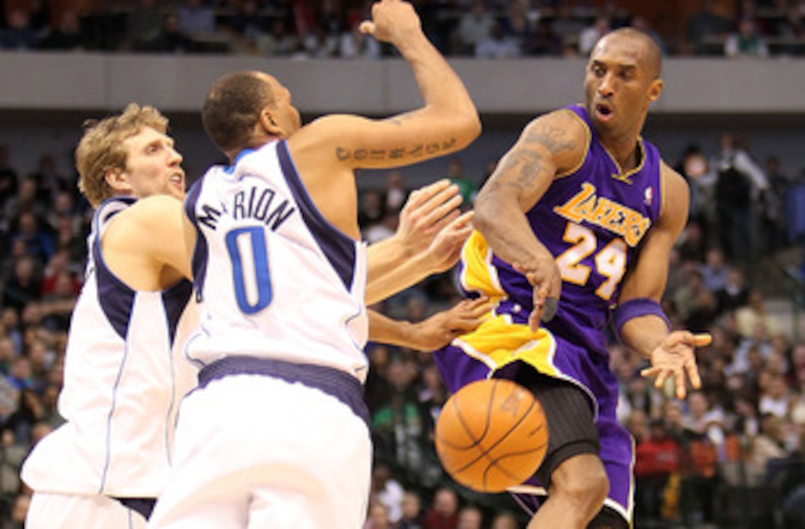 DALLAS - FEBRUARY 24: Kobe Bryant #24 of the Los Angeles Lakers passes against Dirk Nowitzki #41 and Shawn Marion #0 of the Dallas Mavericks on February 24, 2010 at American Airlines Center in Dallas, Texas. NOTE TO USER: User expressly acknowledges and DALLAS - FEBRUARY 24: Kobe Bryant #24 of the Los Angeles Lakers passes against Dirk Nowitzki #41 and Shawn Marion #0 of the Dallas Mavericks on February 24, 2010 at American Airlines Center in Dallas, Texas. NOTE TO USER: User expressly acknowledges and