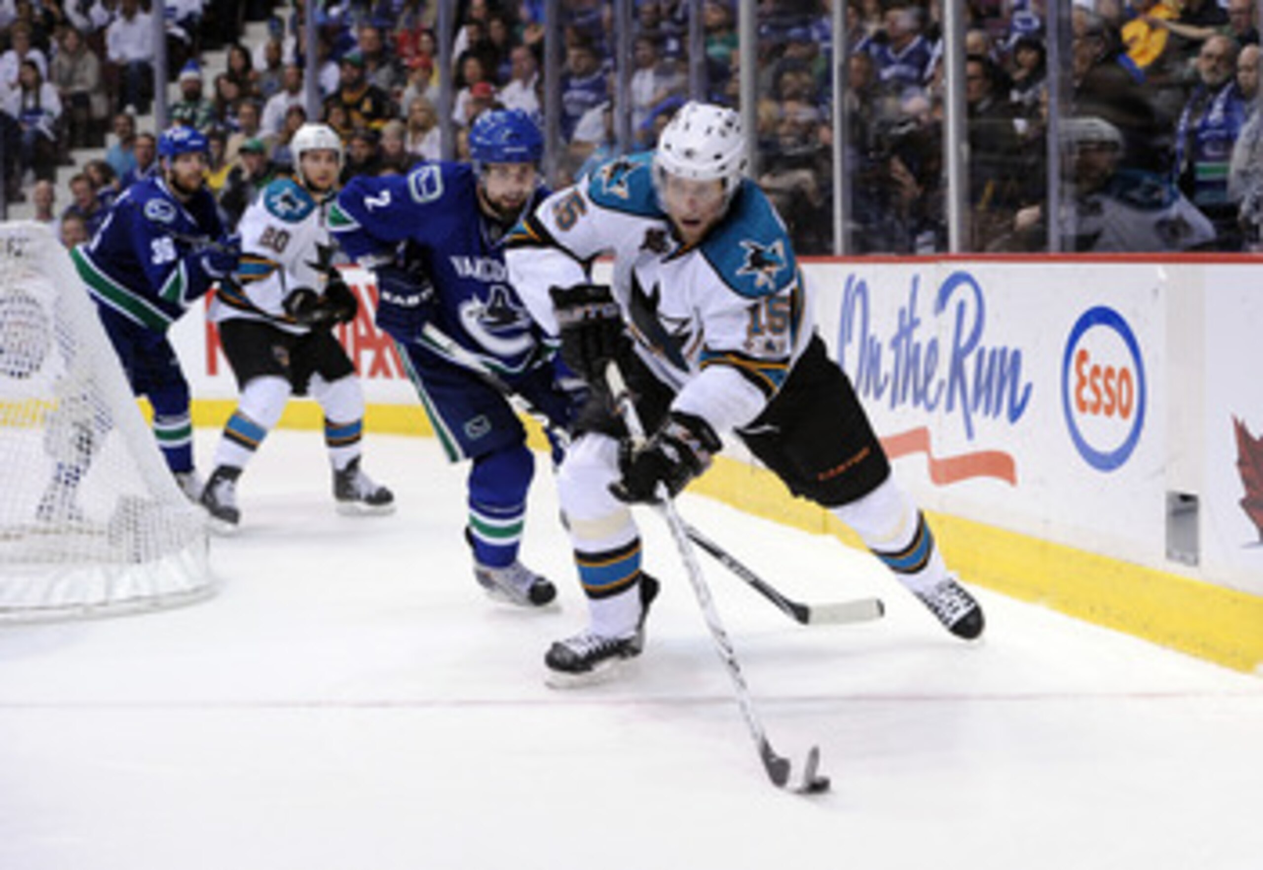 VANCOUVER, CANADA - MAY 24:  Dany Heatley #15 of the San Jose Sharks plays the puck away from Dan Hamhuis #2 of the Vancouver Canucks in Game Five of the Western Conference Finals during the 2011 Stanley Cup Playoffs at Rogers Arena on May 24, 2011 in Van