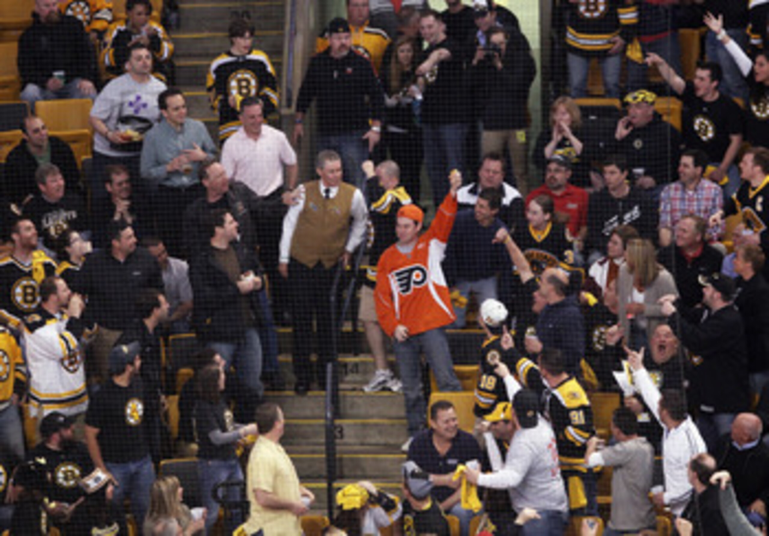 BOSTON, MA - MAY 06: A Philadelphia Flyers fan catches an errant puck amidst the Boston Bruins fans in Game Four of the Eastern Conference Semifinals during the 2011 NHL Stanley Cup Playoffs at TD Garden on May 6, 2011 in Boston, Massachusetts. The Bruins
