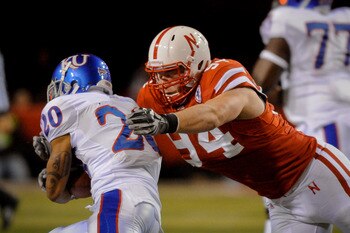 LINCOLN, NE - NOVEMBER 13: Jared Crick #94 of the Nebraska Cornhuskers runs down D.J. Beshears #20 of the Kansas Jayhawks during first half action of their game at Memorial Stadium on November 13, 2010 in Lincoln, Nebraska.  (Photo by Eric Francis/Getty I