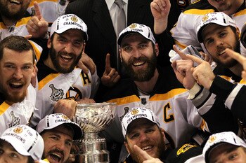 VANCOUVER, BC - JUNE 15:  Patrice Bergeron #37, Mark Recchi #28, Shawn Thornton #22, and Zdeno Chara #33 of the Boston Bruins pose with the Stanley Cup after defeating the Vancouver Canucks in Game Seven of the 2011 NHL Stanley Cup Final at Rogers Arena o