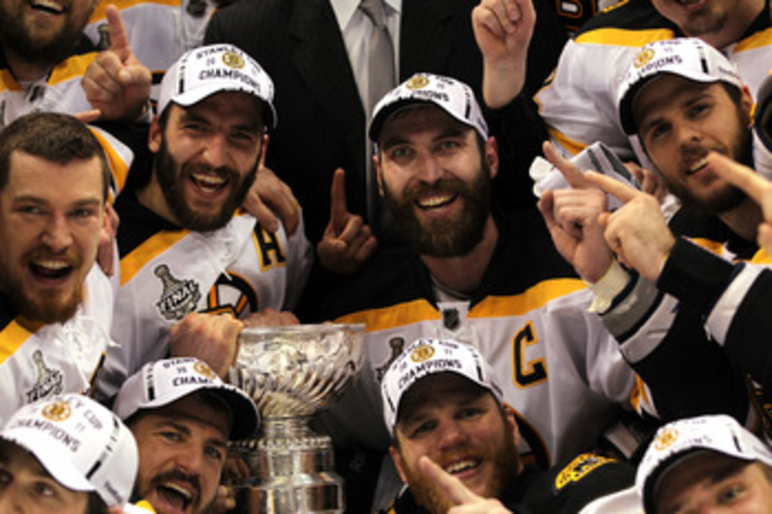 VANCOUVER, BC - JUNE 15:  Patrice Bergeron #37, Mark Recchi #28, Shawn Thornton #22, and Zdeno Chara #33 of the Boston Bruins pose with the Stanley Cup after defeating the Vancouver Canucks in Game Seven of the 2011 NHL Stanley Cup Final at Rogers Arena o