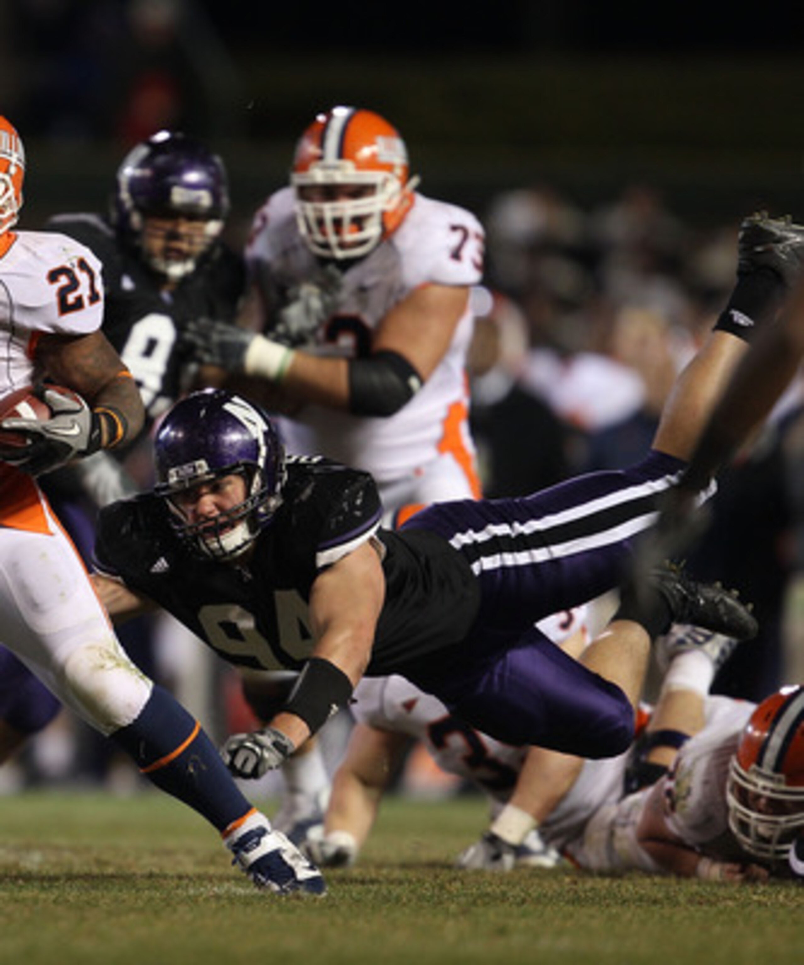CHICAGO - NOVEMBER 20: Jason Ford #21 of the Illinois Fighting Illini breaks away from Vince Browne #94 of the Northwestern Wildcats during a game played at Wrigley Field on November 20, 2010 in Chicago, Illinois. Illinois defeated Northwestern 48-27. (Ph CHICAGO - NOVEMBER 20: Jason Ford #21 of the Illinois Fighting Illini breaks away from Vince Browne #94 of the Northwestern Wildcats during a game played at Wrigley Field on November 20, 2010 in Chicago, Illinois. Illinois defeated Northwestern 48-27. (Ph
