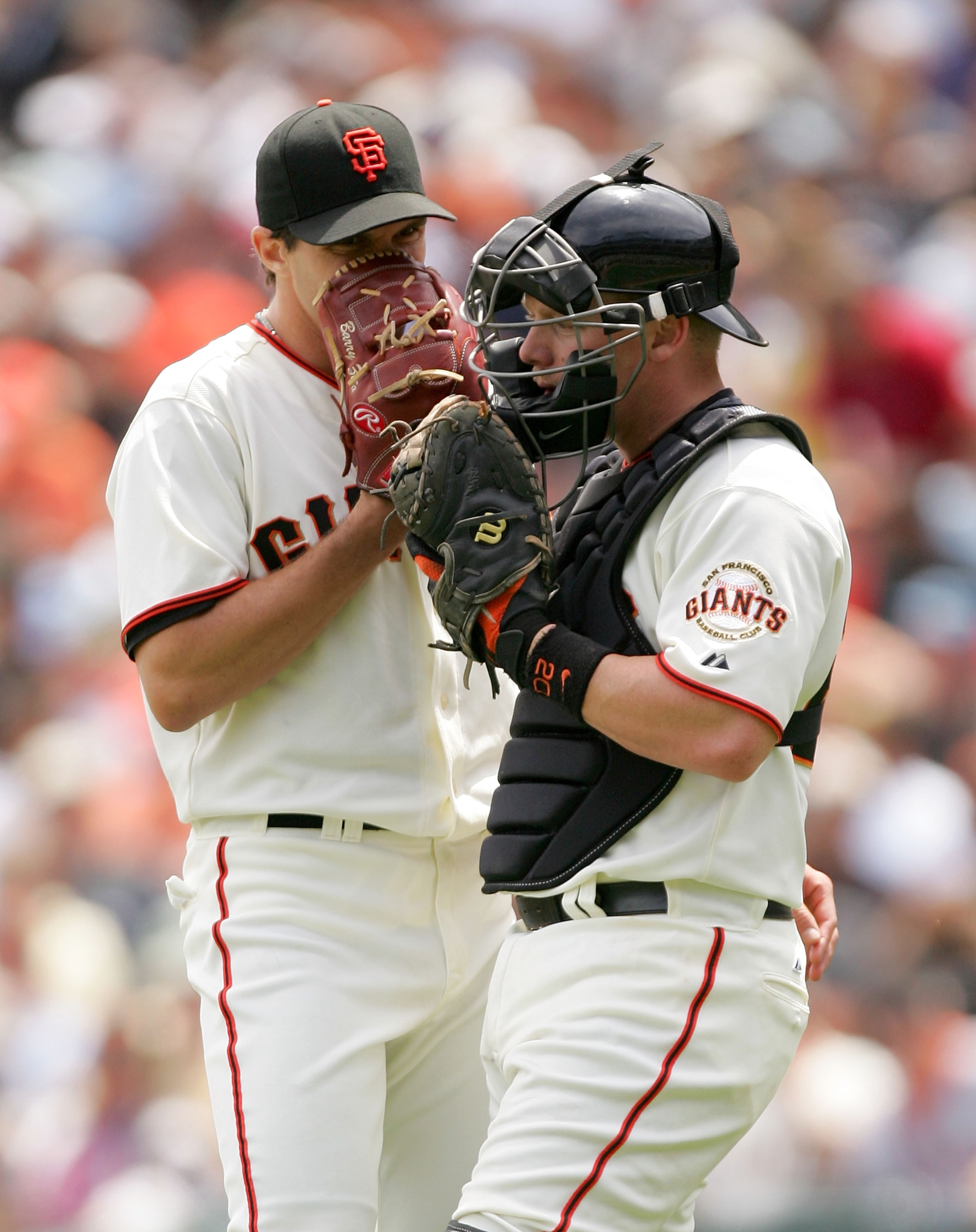 SAN FRANCISCO - MAY 13:  Catcher Steve Holm #20 speaks with Barry Zito #75 of the San Francisco Giants during their game against the Washington Nationals at AT&T Park on May 13, 2009 in San Francisco, California.  (Photo by Ezra Shaw/Getty Images)