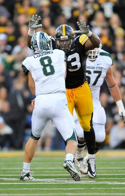 IOWA CITY, IA - OCTOBER 30- Quarterback Kirk Cousins #8 of the Michigan State Spartans throws under pressure from defensive lineman Mike Daniels #93 of the University of Iowa Hawkeyes during the second half of play at Kinnick Stadium on October 30, 2010 i