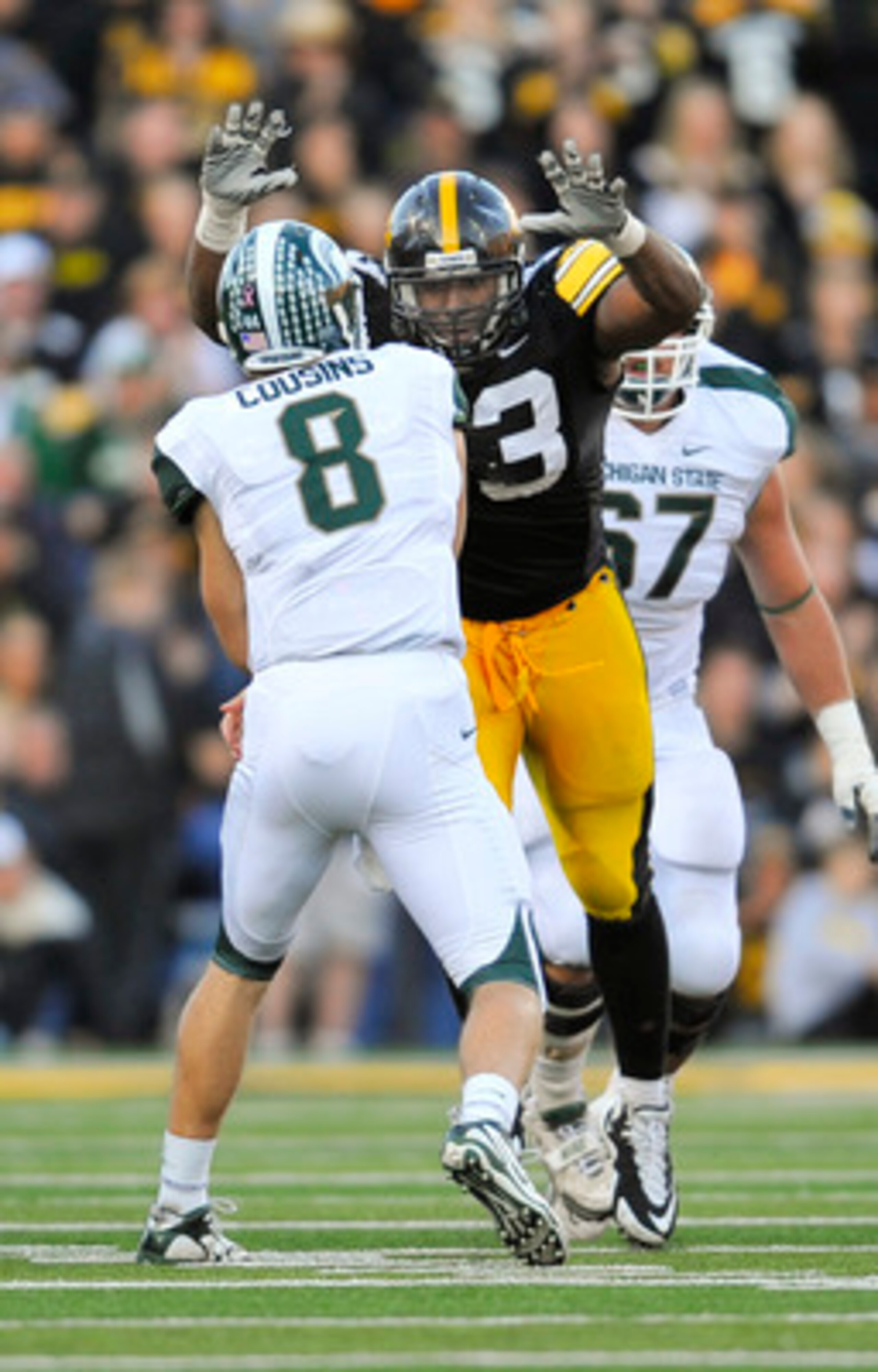 IOWA CITY, IA - OCTOBER 30- Quarterback Kirk Cousins #8 of the Michigan State Spartans throws under pressure from defensive lineman Mike Daniels #93 of the University of Iowa Hawkeyes during the second half of play at Kinnick Stadium on October 30, 2010 i IOWA CITY, IA - OCTOBER 30- Quarterback Kirk Cousins #8 of the Michigan State Spartans throws under pressure from defensive lineman Mike Daniels #93 of the University of Iowa Hawkeyes during the second half of play at Kinnick Stadium on October 30, 2010 i