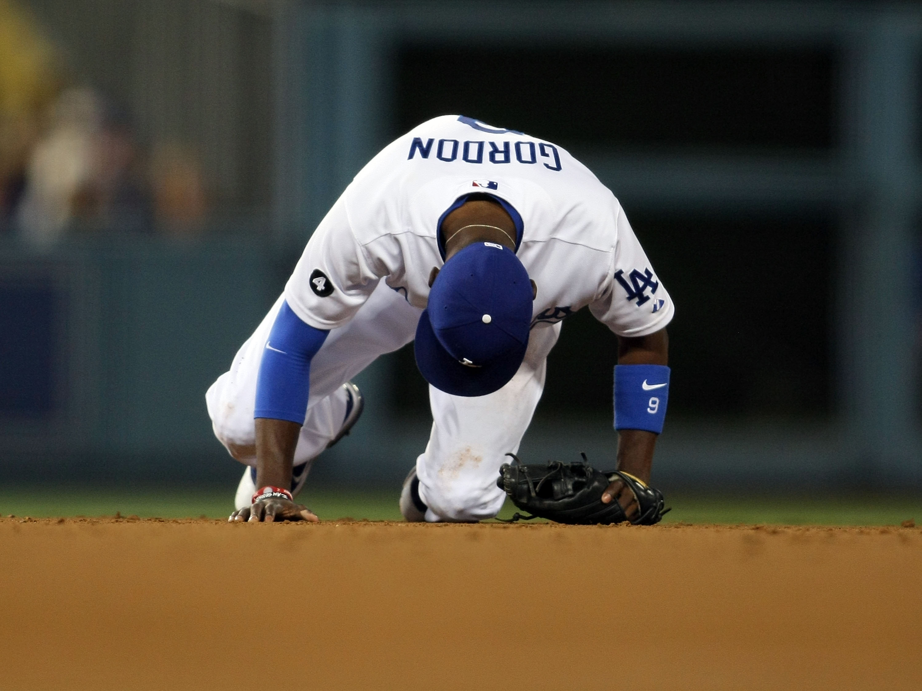 LOS ANGELES, CA - JUNE 17:  Dee Gordon #9 of the Los Angeles Dodgers stays down on the ground after a collision on a play at second base in the sixth inning during the MLB game against the Houston Astros at Dodger Stadium on June 17, 2011 in Los Angeles,