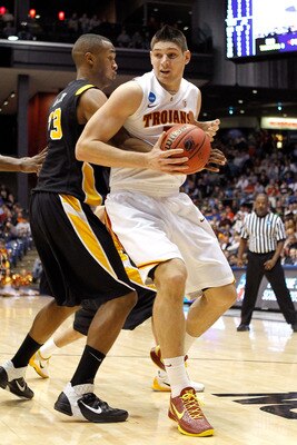 DAYTON, OH - MARCH 16: Nikola Vucevic #5 of the USC Trojans handles the ball against D.J. Haley #33 of the Virginia Commonwealth Rams during the first round of the 2011 NCAA men's basketball tournament at UD Arena on March 16, 2011 in Dayton, Ohio.  (Phot