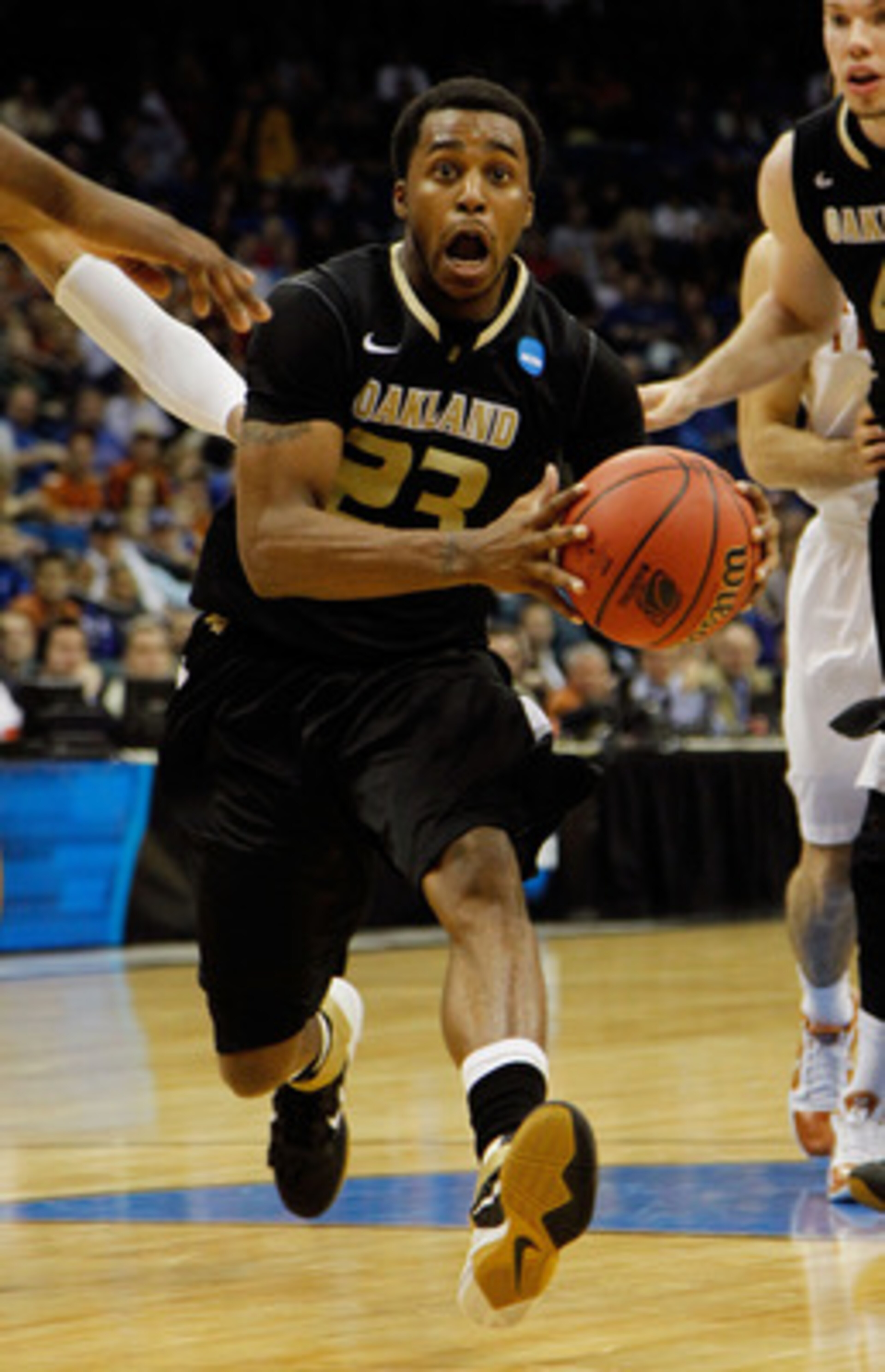 TULSA, OK - MARCH 18: Reggie Hamilton #23 of the Oakland Golden Grizzlies drives with the ball against the Texas Longhorns during the second round of the 2011 NCAA men's basketball tournament at BOK Center on March 18, 2011 in Tulsa, Oklahoma. (Photo by TULSA, OK - MARCH 18: Reggie Hamilton #23 of the Oakland Golden Grizzlies drives with the ball against the Texas Longhorns during the second round of the 2011 NCAA men's basketball tournament at BOK Center on March 18, 2011 in Tulsa, Oklahoma. (Photo by