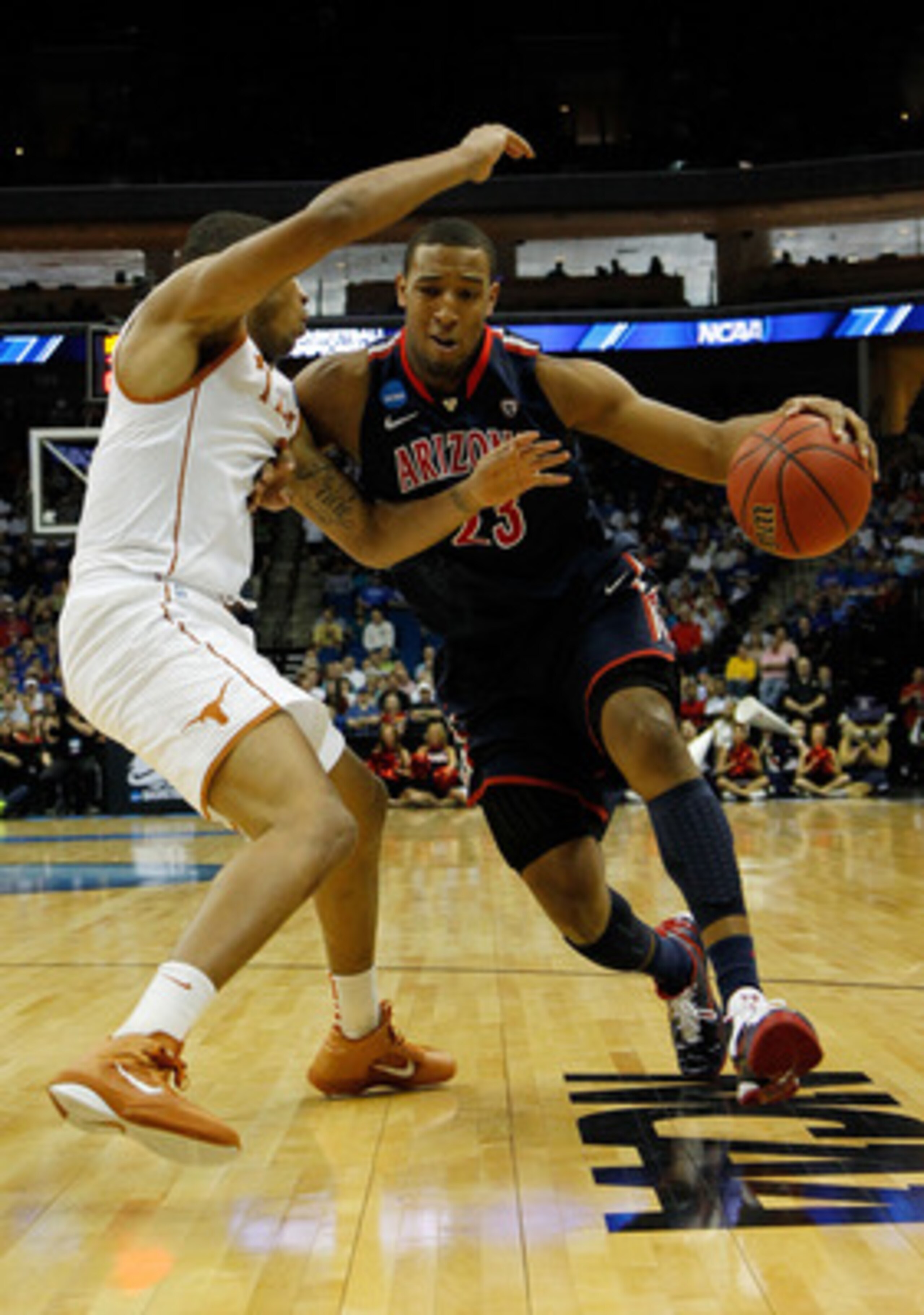 TULSA, OK - MARCH 20:  Derrick Williams #23 of the Arizona Wildcats drives with the ball against Gary Johnson #1 of the Texas Longhorns during the third round of the 2011 NCAA men's basketball tournament at BOK Center on March 20, 2011 in Tulsa, Oklahoma.