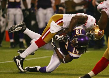 MINNEAPOLIS - SEPTEMBER 27: Takeo Spikes #51 of the San Francisco 49ers tackles Sidney Rice #18 of the Minnesota Vikings at the Hubert H. Humphrey Metrodome on September 27, 2009 in Minneapolis, Minnesota. The Vikings defeated the 49ers 27-24.  (Photo by