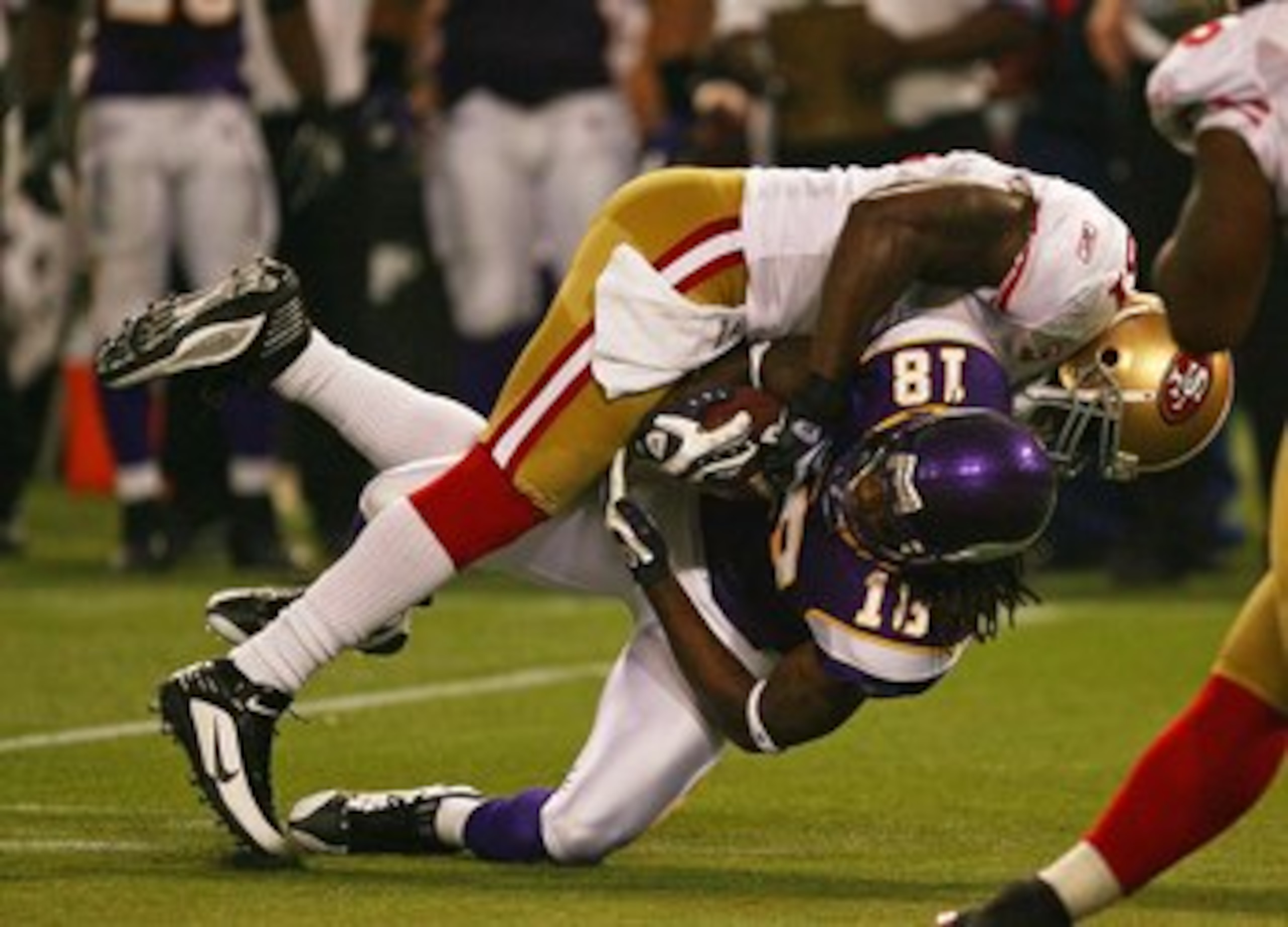 MINNEAPOLIS - SEPTEMBER 27: Takeo Spikes #51 of the San Francisco 49ers tackles Sidney Rice #18 of the Minnesota Vikings at the Hubert H. Humphrey Metrodome on September 27, 2009 in Minneapolis, Minnesota. The Vikings defeated the 49ers 27-24.  (Photo by