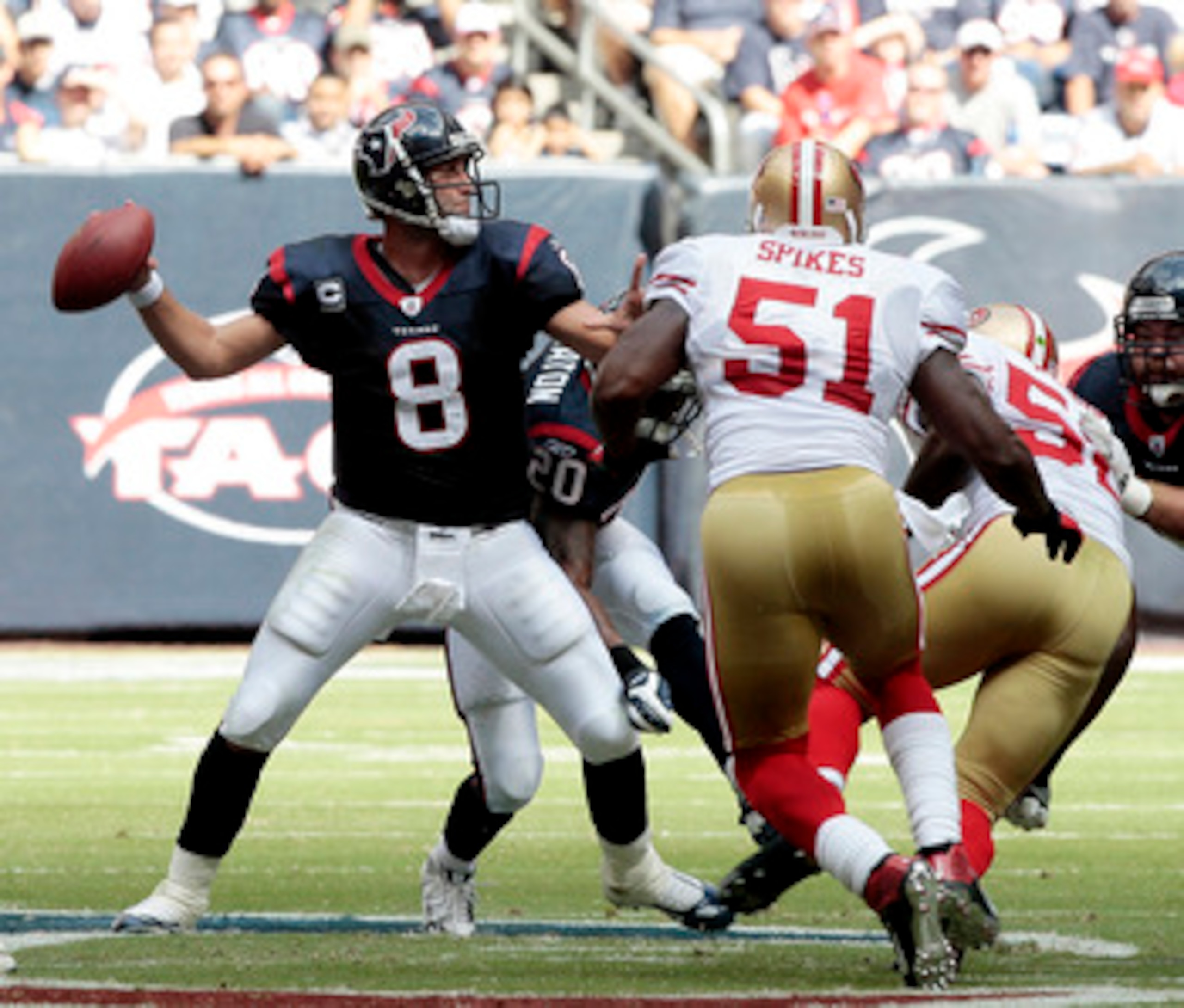 HOUSTON - OCTOBER 25:  Quarterback Matt Schaub #8 of the Houston Texans looks downfield for a receiver as linebacker Takeo Spikes #51 of the San Francisco 49ers applies pressure at Reliant Stadium on October 25, 2009 in Houston, Texas.  (Photo by Bob Leve