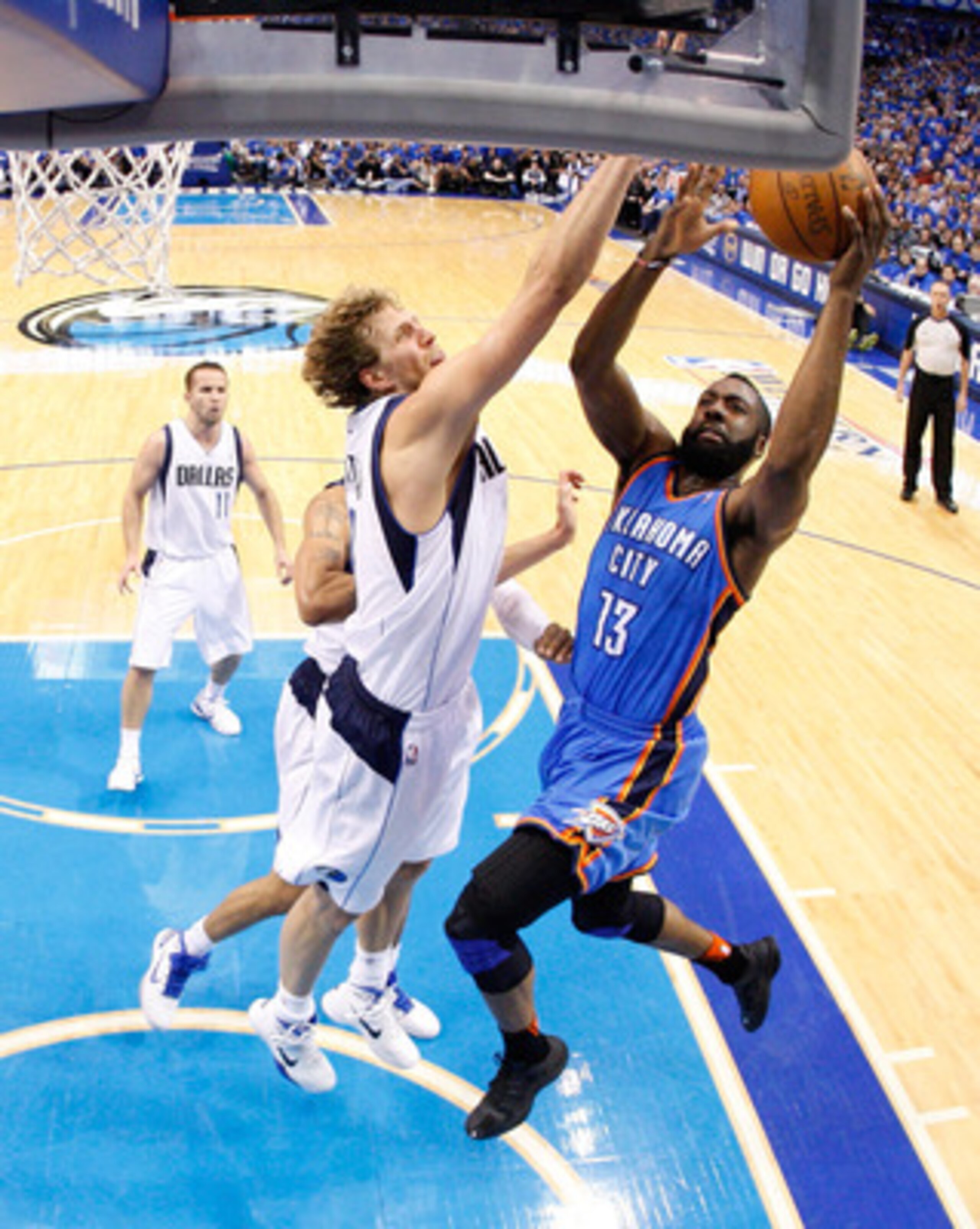 DALLAS, TX - MAY 25:  James Harden #13 of the Oklahoma City Thunder goes up for a layup against Dirk Nowitzki #41 of the Dallas Mavericks in the first half in Game Five of the Western Conference Finals during the 2011 NBA Playoffs at American Airlines Cen