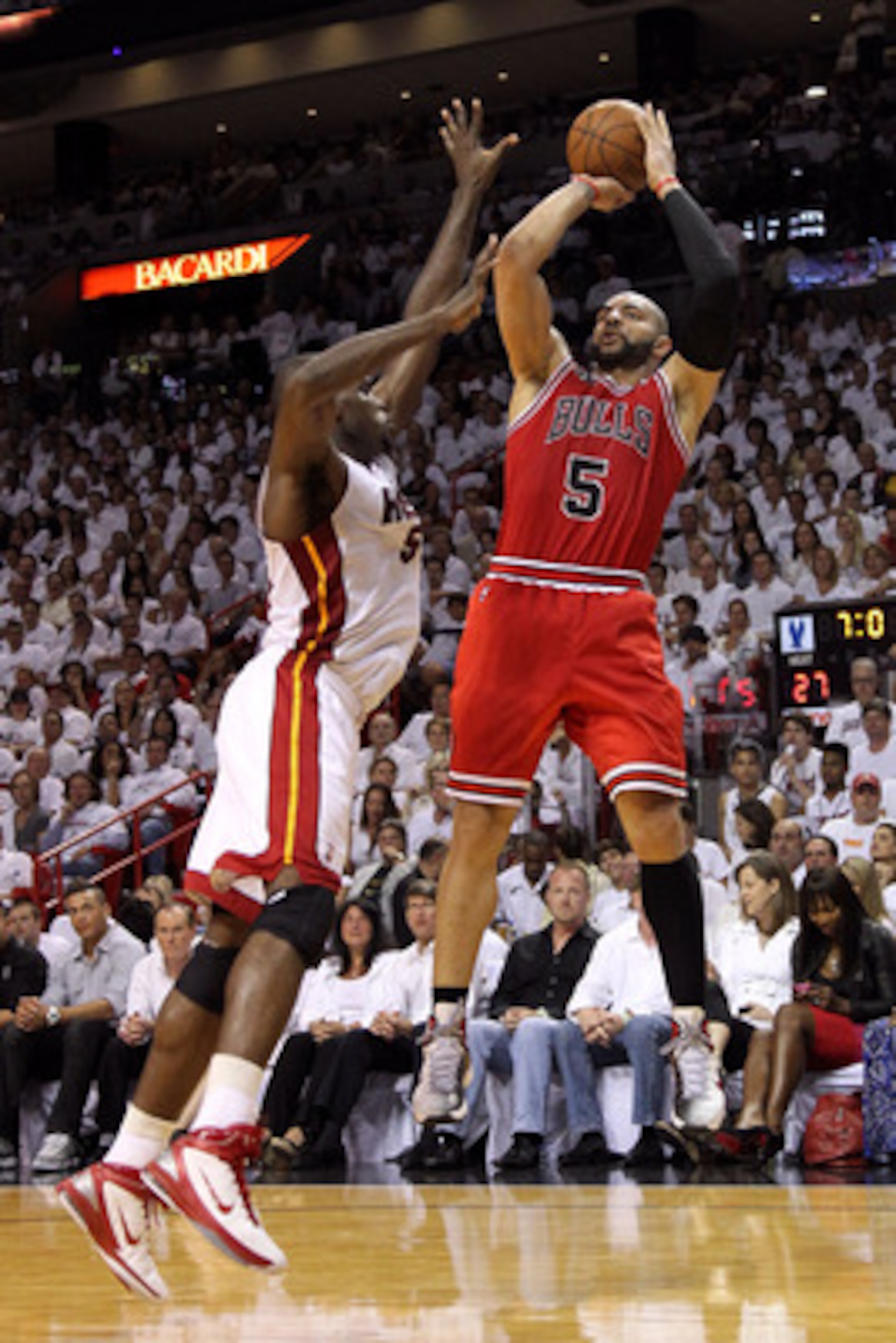 MIAMI, FL - MAY 22: Carlos Boozer #5 of the Chicago Bulls attempts a shot against Joel Anthony #50 of the Miami Heat in Game Three of the Eastern Conference Finals during the 2011 NBA Playoffs on May 22, 2011 at American Airlines Arena in Miami, Florida. MIAMI, FL - MAY 22: Carlos Boozer #5 of the Chicago Bulls attempts a shot against Joel Anthony #50 of the Miami Heat in Game Three of the Eastern Conference Finals during the 2011 NBA Playoffs on May 22, 2011 at American Airlines Arena in Miami, Florida.