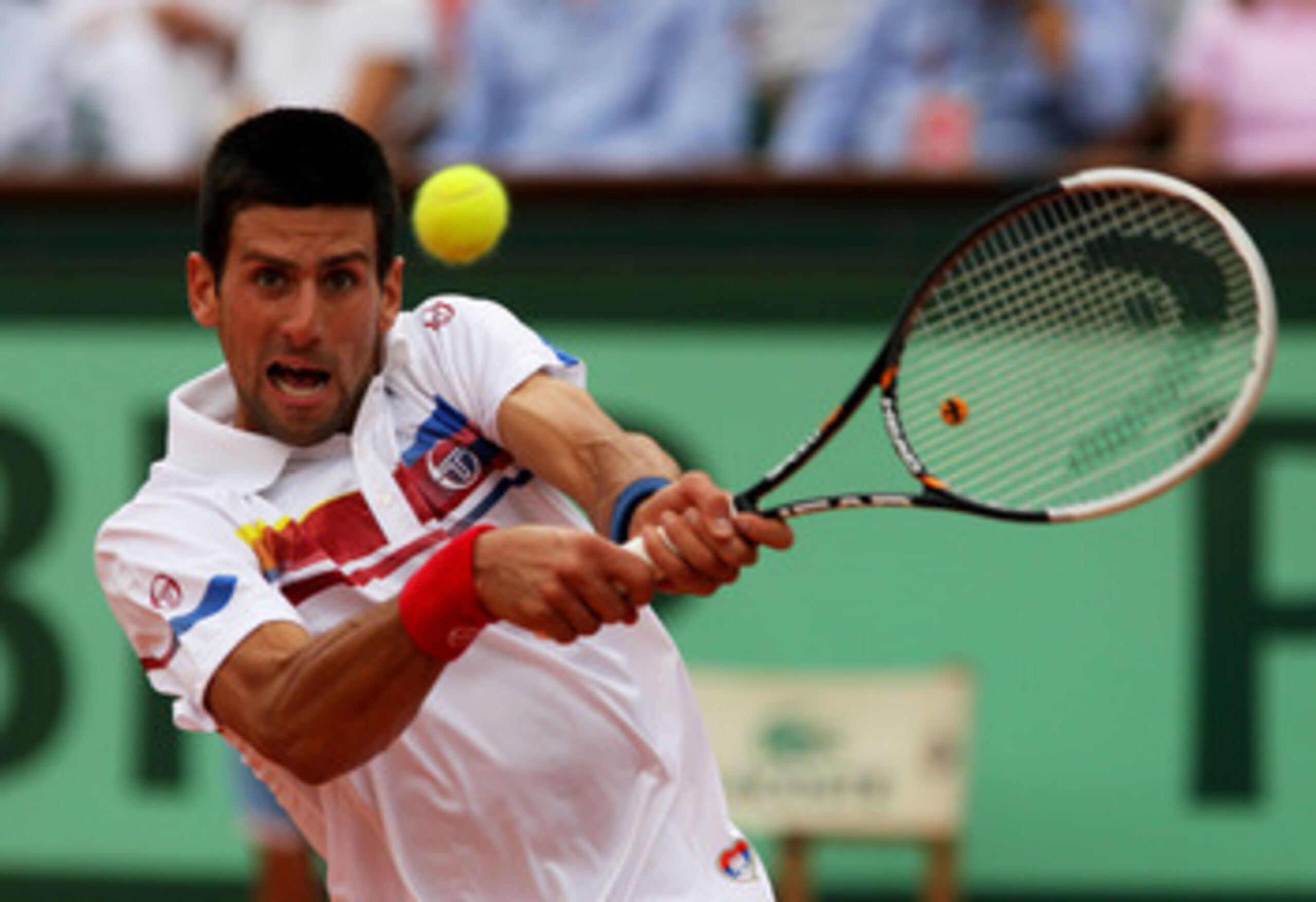 PARIS, FRANCE - JUNE 03:  Novak Djokovic of Serbia hits a backhand during the men's singles semi final match between Roger Federer of Switzerland and Novak Djokovic of Serbia on day thirteen of the French Open at Roland Garros on June 3, 2011 in Paris, Fr