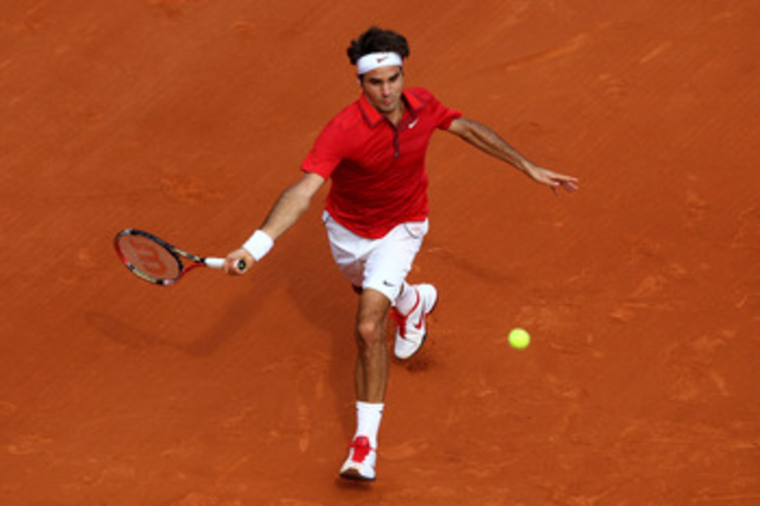 PARIS, FRANCE - JUNE 05:  Roger Federer of Switzerland hits a forehand during the men's singles final match between Rafael Nadal of Spain and Roger Federer of Switzerland on day fifteen of the French Open at Roland Garros on June 5, 2011 in Paris, France.