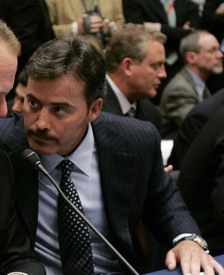 WASHINGTON - MARCH 17:  Former St. Louis Cardinal Mark McGwire (L) talks with Rafael Palmeiro of the Baltimore Orioles during a House Committe session investigating Major League Baseball's effort to eradicate steroid use on Capitol Hill March 17, 2005 in