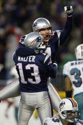 FOXBORO, MA - DECEMBER 29:  Adam Vinatieri #4 is lifted up by kick holder Ken Walter #13 of the New England Patriots after Vinatieri kicked a game-winning field goal in overtime to beat the Miami Dolphins at Gillette Stadium on December 29, 2002 in Foxbor
