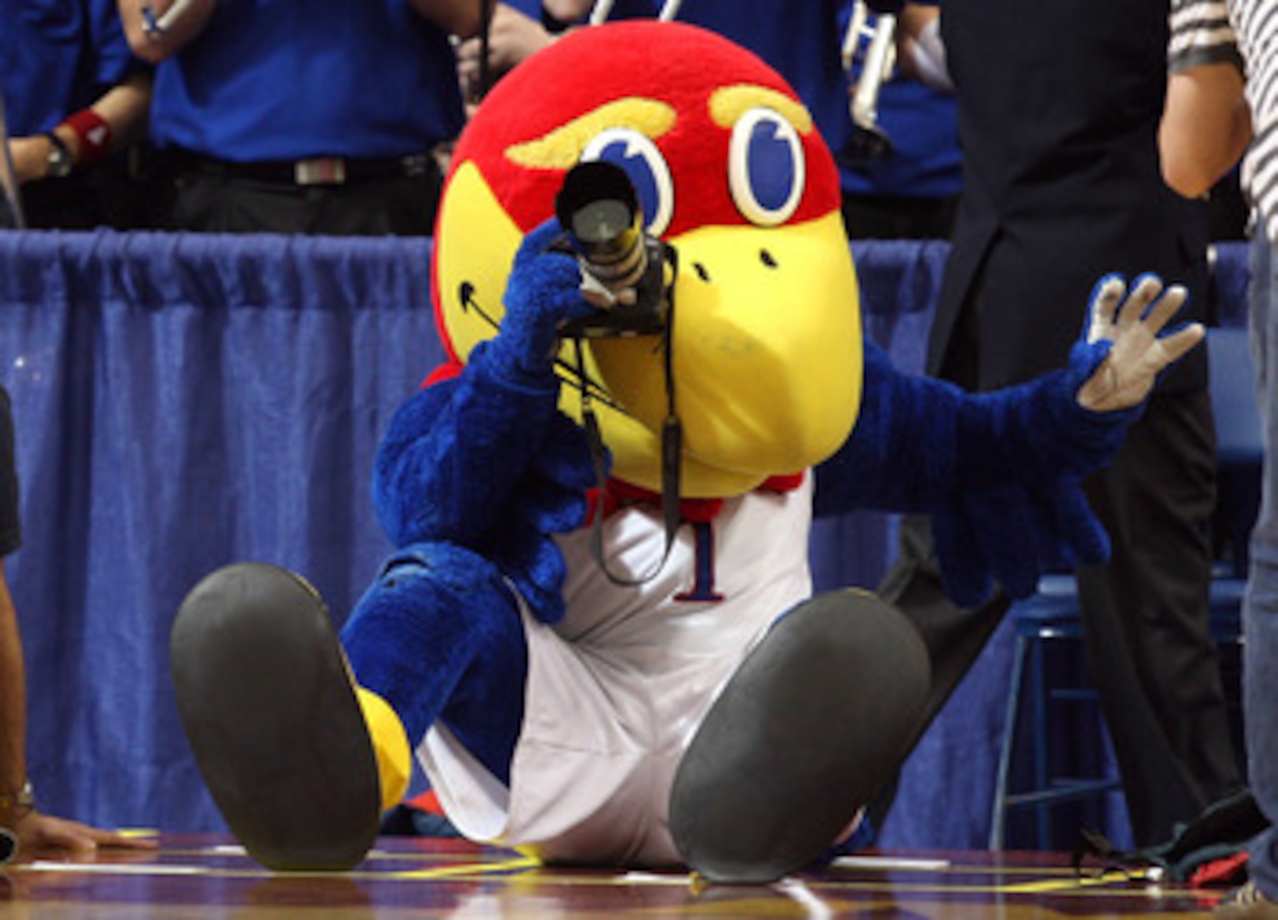 MINNEAPOLIS - MARCH 22: Jayhawk, the mascot for the Kansas Jayhawks takes pictures with a camera from the photographer row against the Dayton Flyers during the second round of the NCAA Division I Men's Basketball Tournament at the Hubert H. Humphrey Metr MINNEAPOLIS - MARCH 22: Jayhawk, the mascot for the Kansas Jayhawks takes pictures with a camera from the photographer row against the Dayton Flyers during the second round of the NCAA Division I Men's Basketball Tournament at the Hubert H. Humphrey Metr