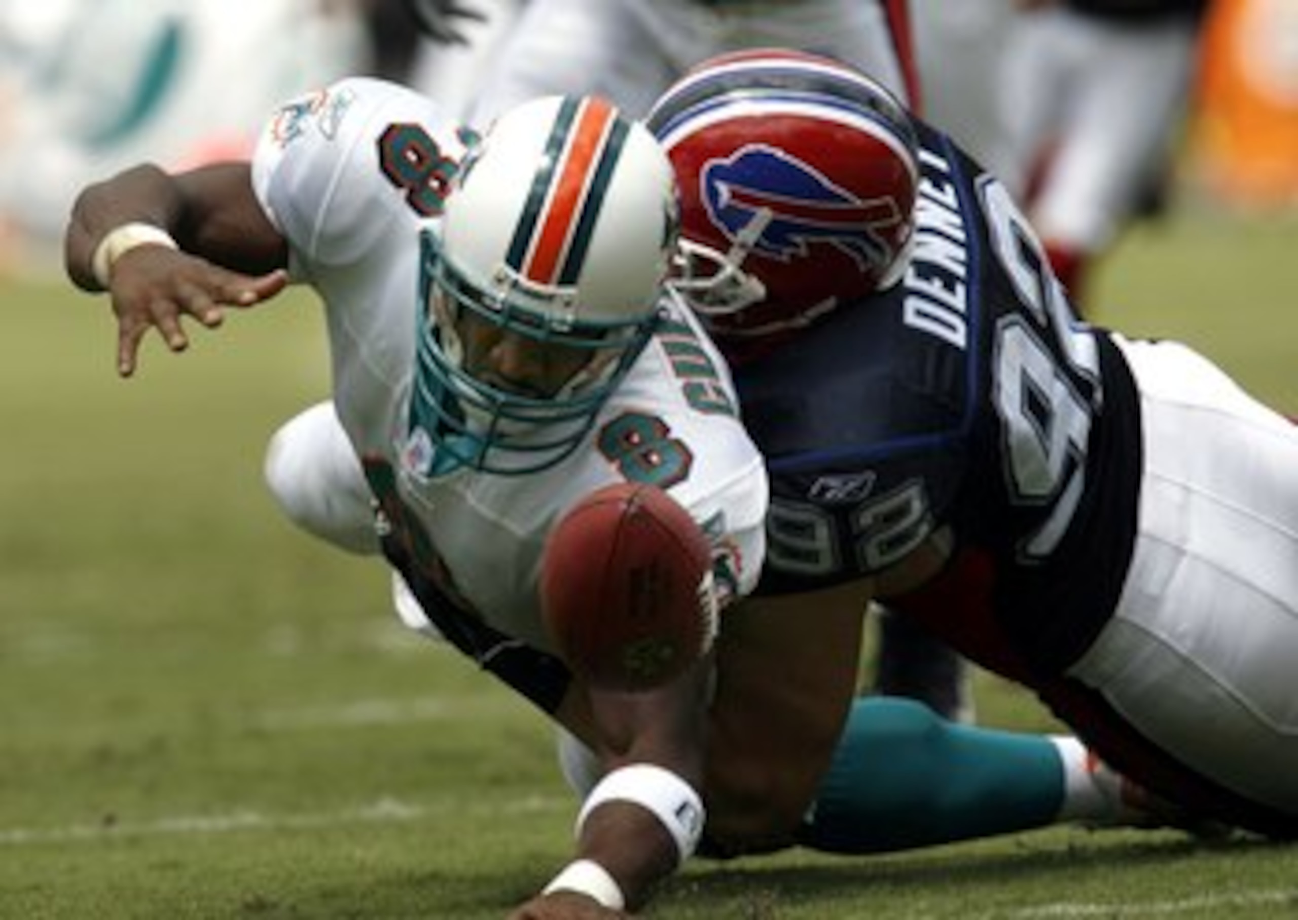 MIAMI - SEPTEMBER 17:  Quarterback Daunte Culpepper #8 of the Miami Dolphins is sacked by defensive end Ryan Denney #92 of the Buffalo Bills in the first quarter on September 17, 2006 at Miami Dolphin Stadium in Miami, Florida.  (Photo by Eliot J. Schecht