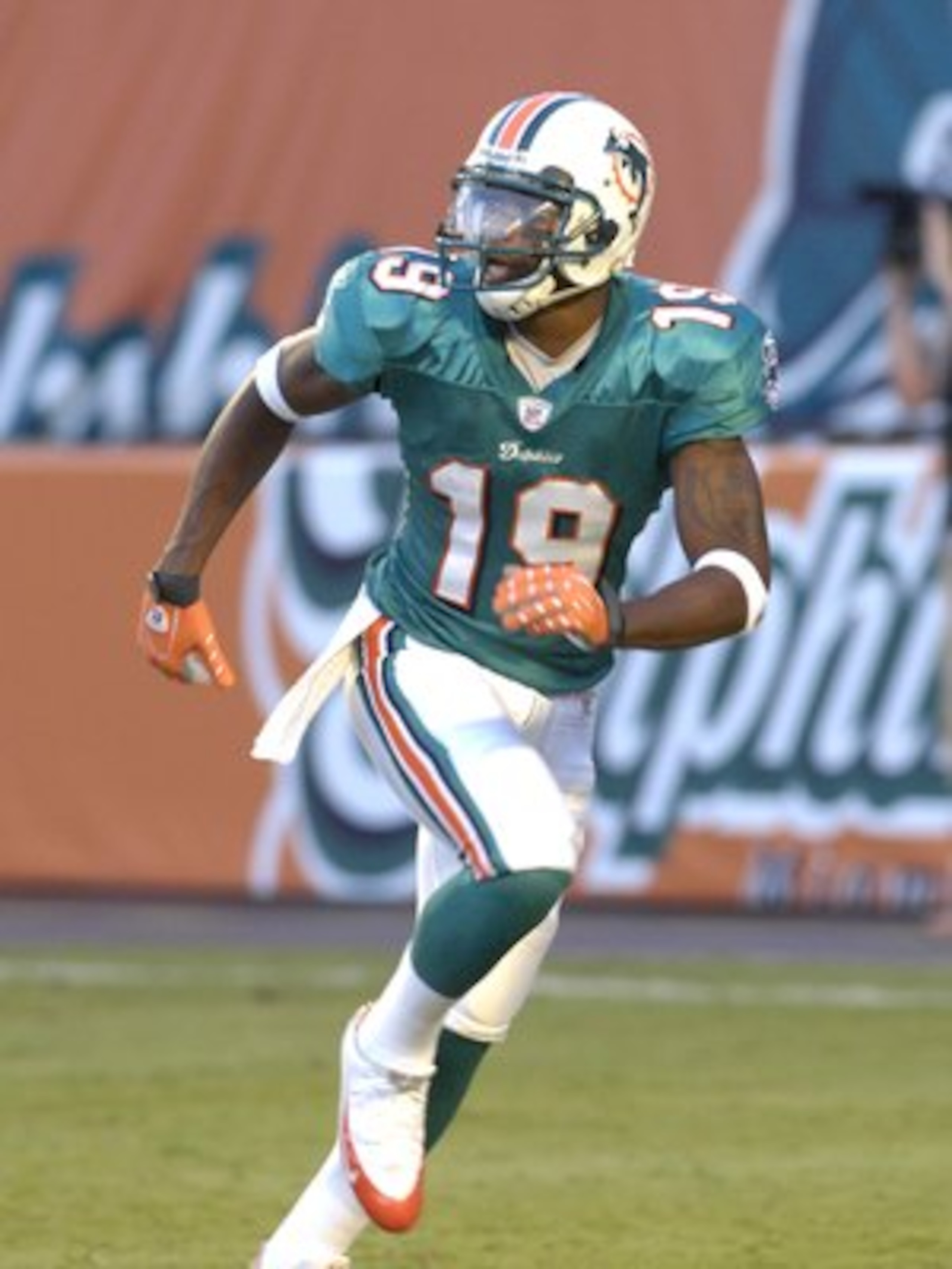 MIAMI, FL - AUGUST 11: Wide receiver Ted Ginn Jr. #19 of the Miami Dolphins  warms up for play  against the Jacksonville Jaguars at Dolphin Stadium on August 11, 2007 in Miami, Florida. (Photo by Al Messerschmidt/Getty Images)