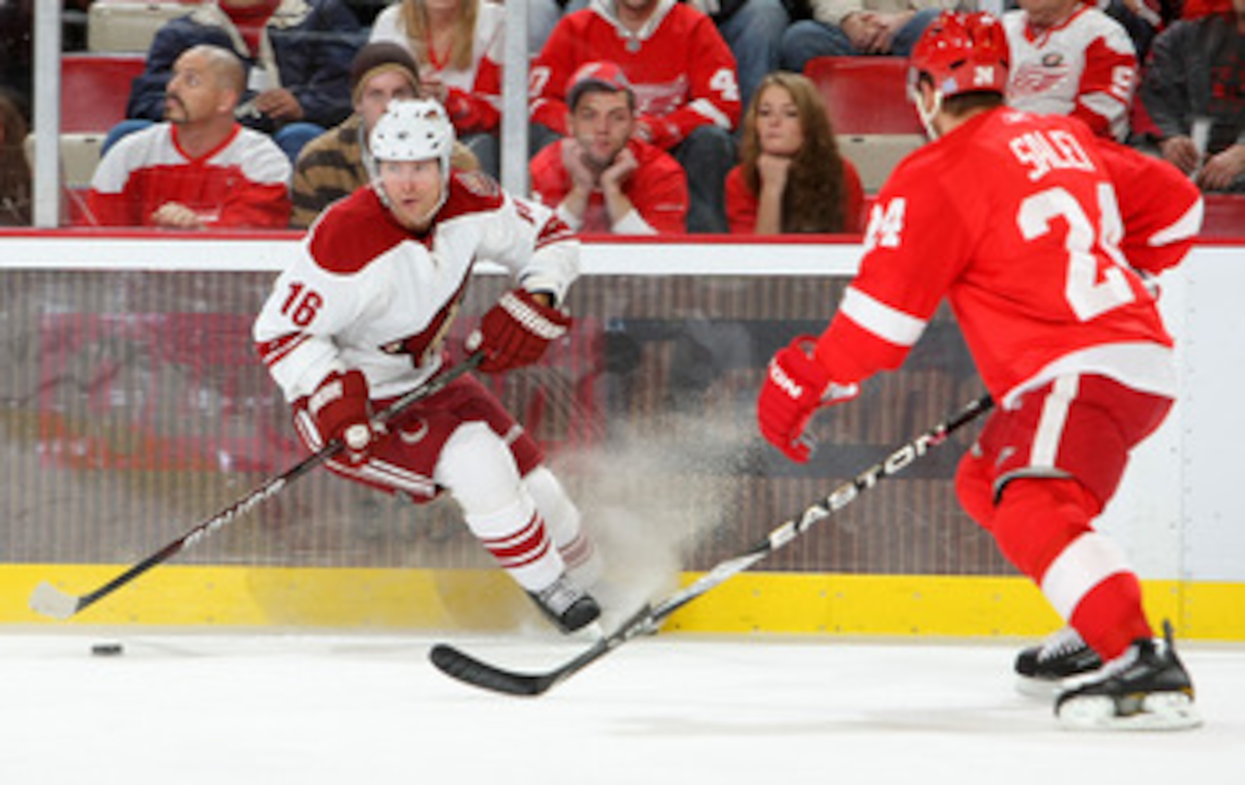 DETROIT - OCTOBER 28:  Petr Prucha #16 of the Phoenix Coyotes carries the puck as Ruslan Salei #24 of the Detroit Red Wings defends during their NHL game at Joe Louis Arena on October 28, 2010 in Detroit, Michigan.(Photo By Dave Sandford/Getty Images)