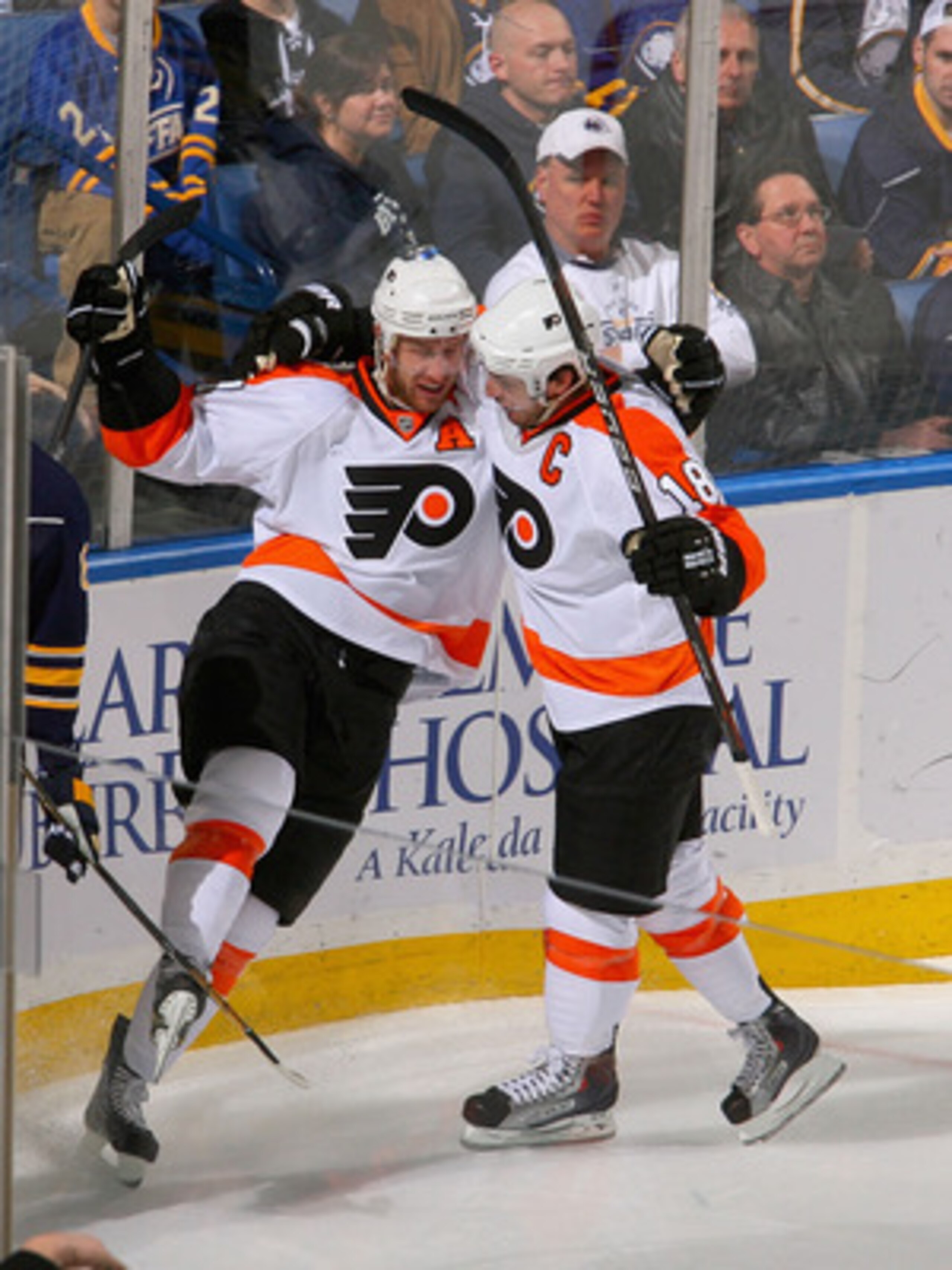 BUFFALO, NY - APRIL 18:  Jeff Carter #17 and Mike Richards #18 of  the Philadelphia Flyers celebrate after Carter scored Philadelphia's first goal against the Buffalo Sabres in Game Three of the Eastern Conference Quarterfinals during the 2011 NHL Stanley