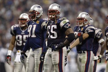 HOUSTON - FEBRUARY 1:  Defensive end Willie McGinest #55 of the New England Patriots stands next to defensive end Bobby Hamilton #91 in Super Bowl XXXVIII against the Carolina Panthers at Reliant Stadium on February 1, 2004 in Houston, Texas.  The Patriot