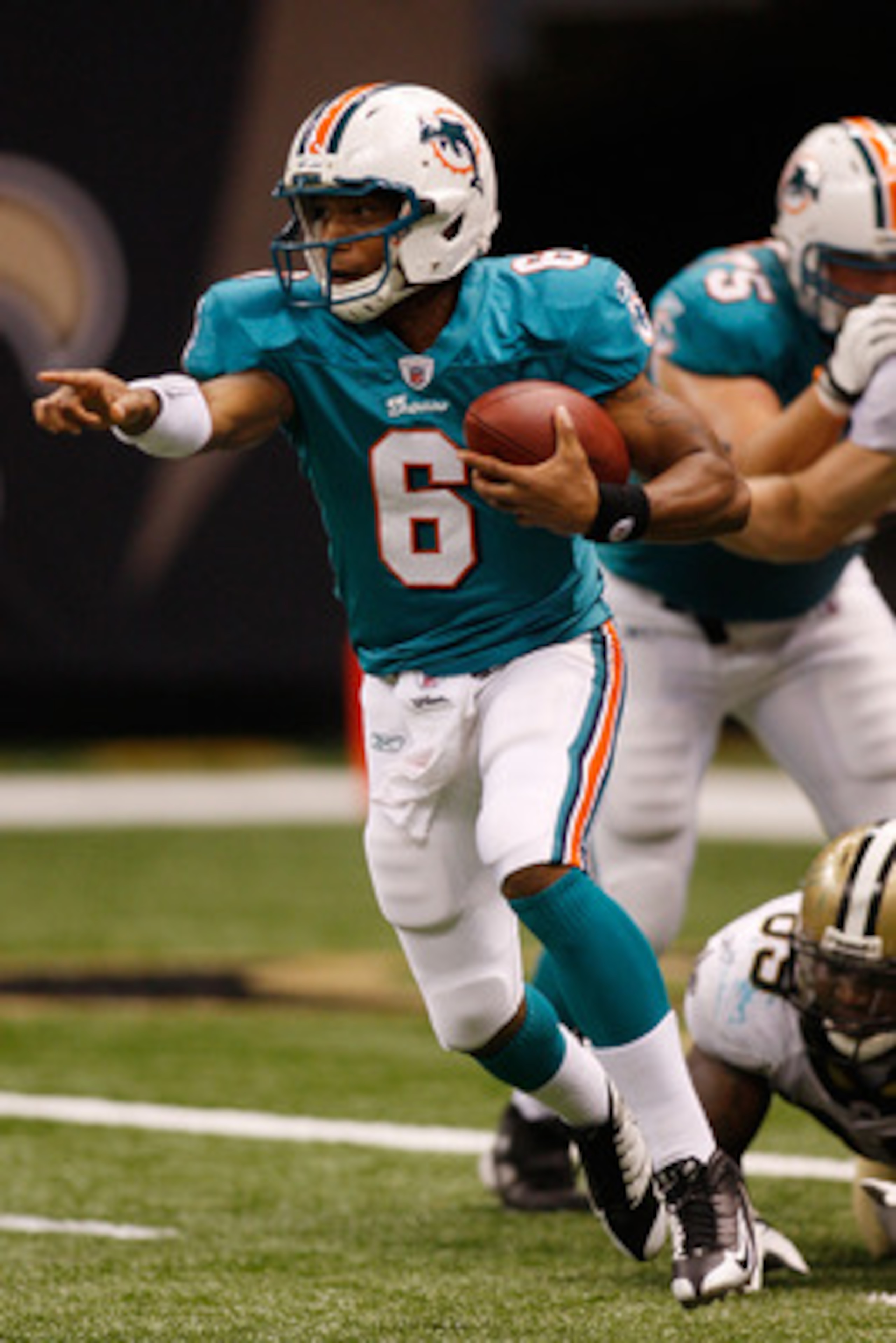 NEW ORLEANS - SEPTEMBER 03:  Quarterback Pat White #6 of the Miami Dolphins looks to avoid a tackle against the New Orleans Saints at the Louisiana Superdome on September 3, 2009 in New Orleans, Louisiana. The Dolphins defeated the Saints 10-7.   (Photo b