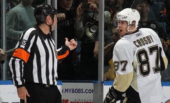 UNIONDALE, NY - APRIL 11: Sidney Crosby #87 of the Pittsburgh Penguins is sent to the penalty box by referee Stephane Auger #15 in his game against the New York Islanders at the Nassau Coliseum on April 11, 2010 in Uniondale, New York. (Photo by Bruce Ben