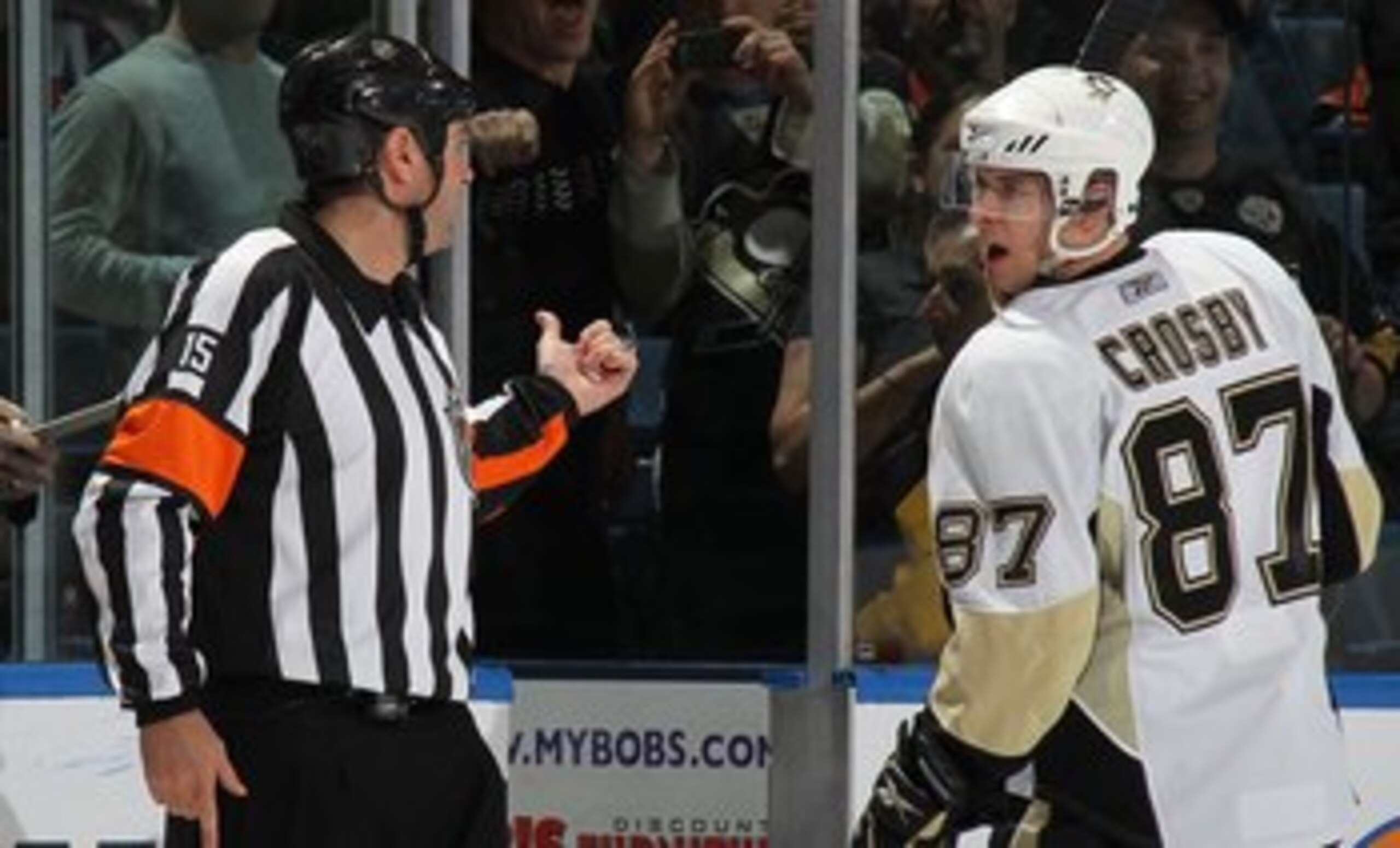 UNIONDALE, NY - APRIL 11: Sidney Crosby #87 of the Pittsburgh Penguins is sent to the penalty box by referee Stephane Auger #15 in his game against the New York Islanders at the Nassau Coliseum on April 11, 2010 in Uniondale, New York. (Photo by Bruce Ben