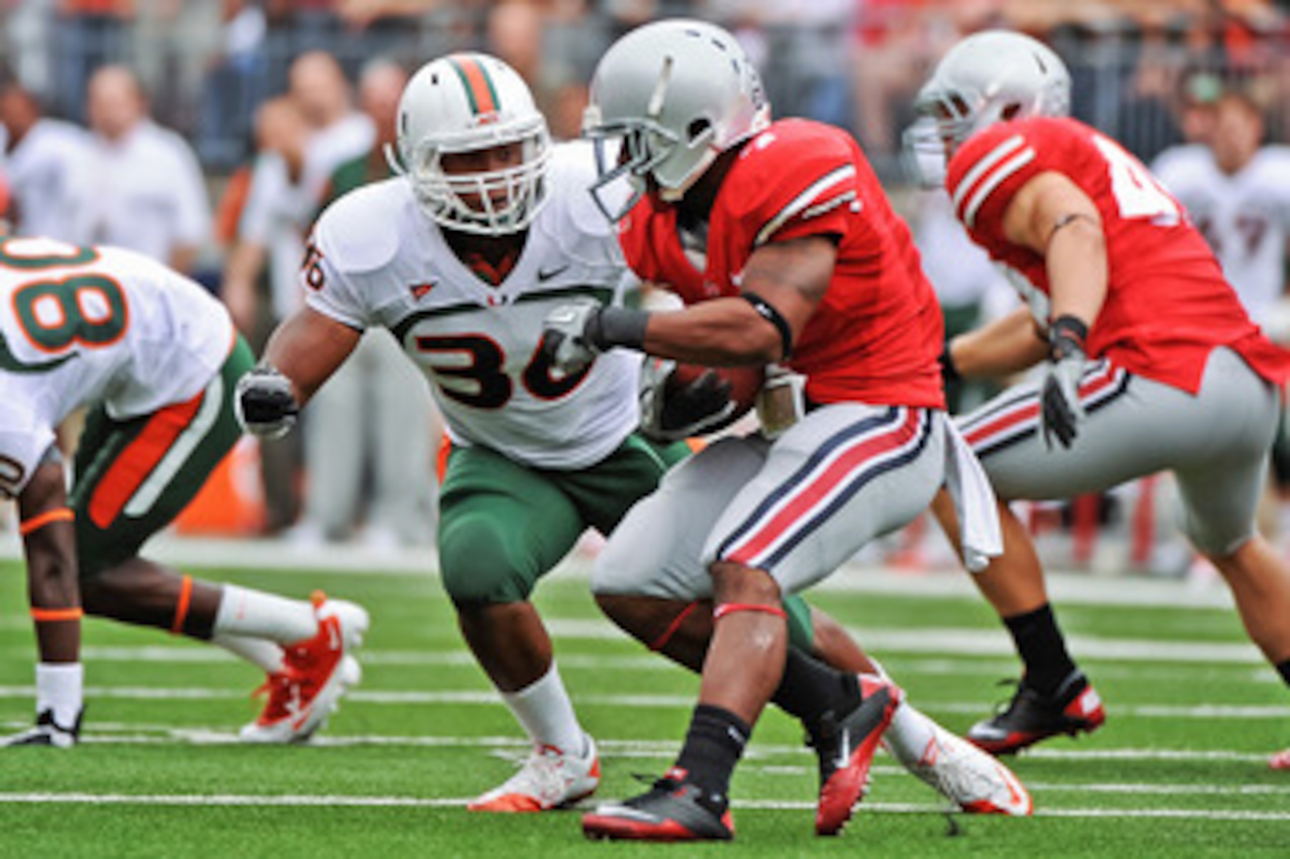 COLUMBUS, OH - SEPTEMBER 11:  Kylan Robinson #36 of the Miami Hurricanes tackles Jordan Hall #7 of the Ohio State Buckeyes  at Ohio Stadium on September 11, 2010 in Columbus, Ohio.  (Photo by Jamie Sabau/Getty Images)
