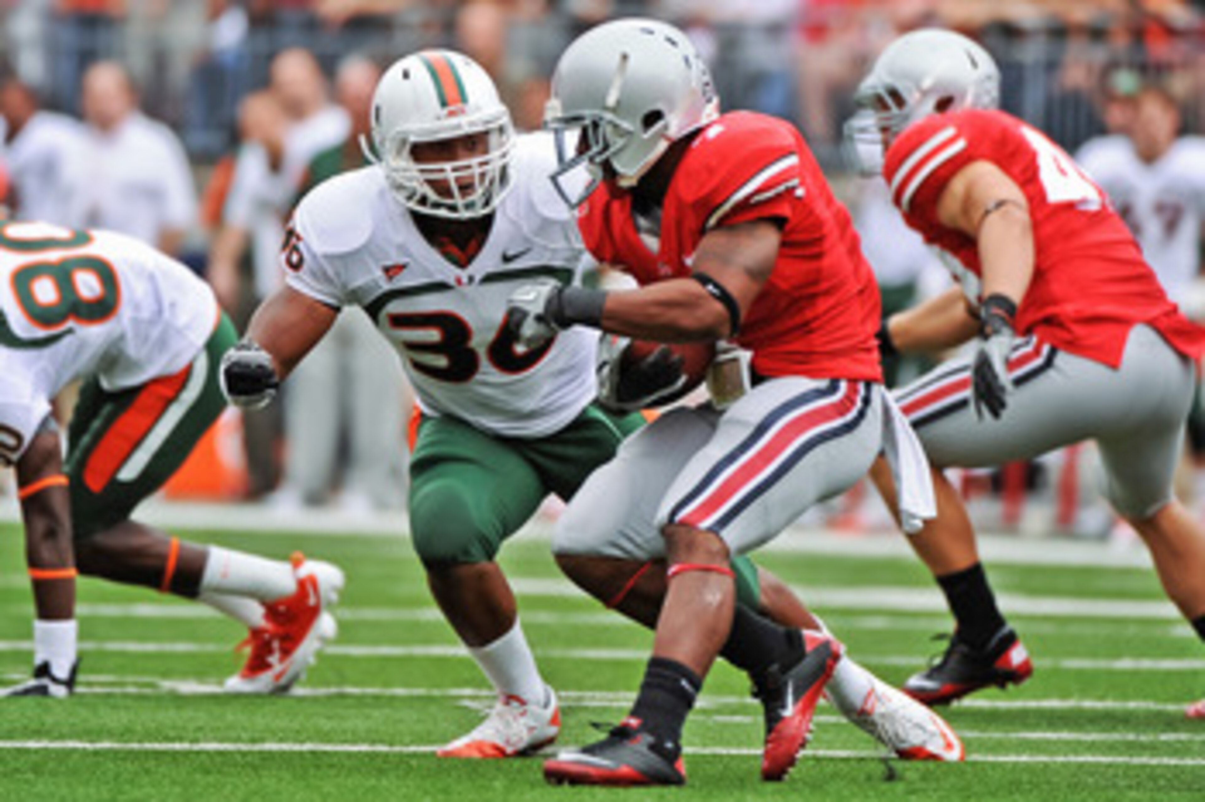COLUMBUS, OH - SEPTEMBER 11:  Kylan Robinson #36 of the Miami Hurricanes tackles Jordan Hall #7 of the Ohio State Buckeyes  at Ohio Stadium on September 11, 2010 in Columbus, Ohio.  (Photo by Jamie Sabau/Getty Images)