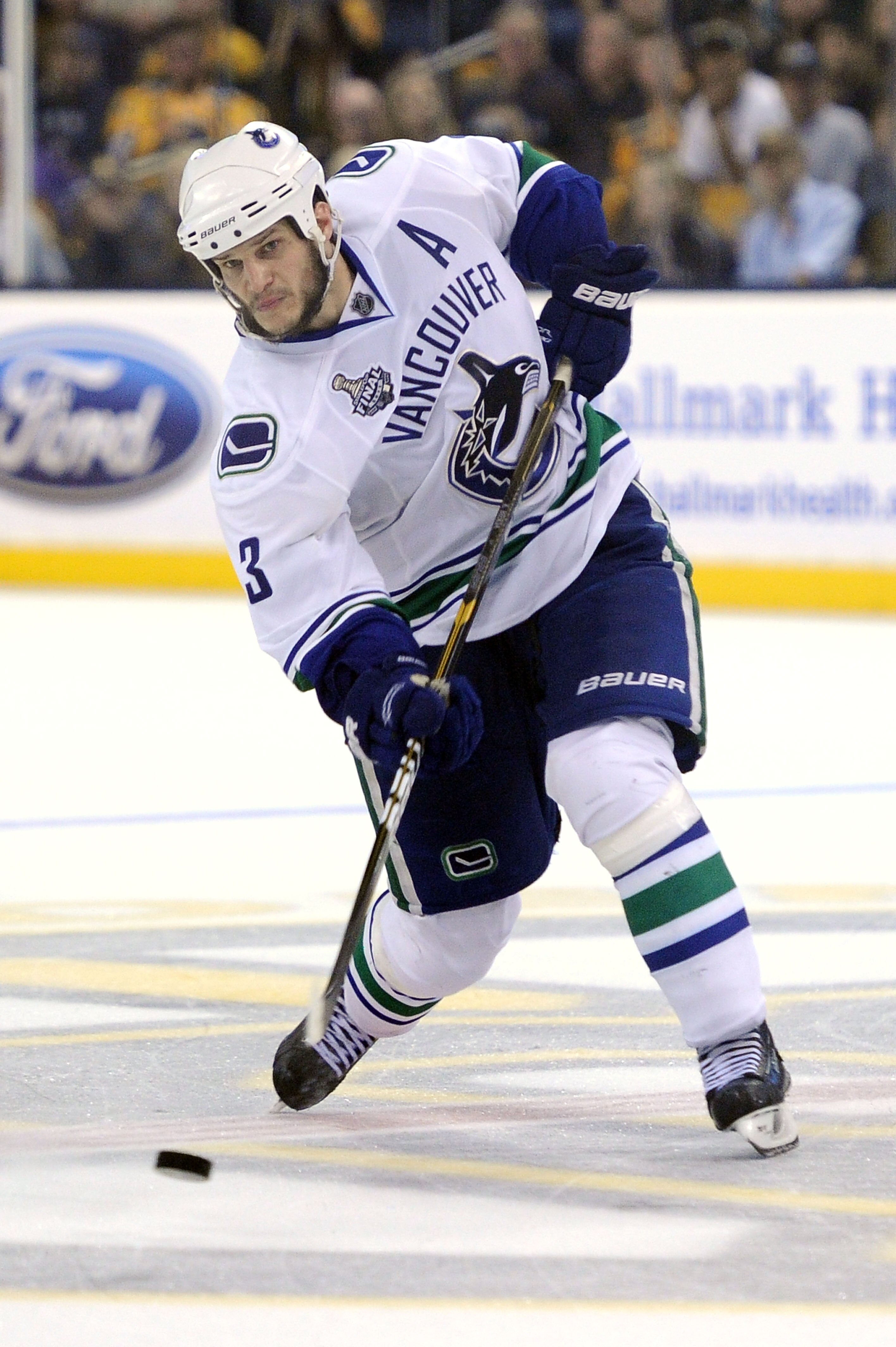 BOSTON, MA - JUNE 13:  Kevin Bieksa #3 of the Vancouver Canucks takes a shot against the Boston Bruins during Game Six of the 2011 NHL Stanley Cup Final at TD Garden on June 13, 2011 in Boston, Massachusetts.  (Photo by Harry How/Getty Images)