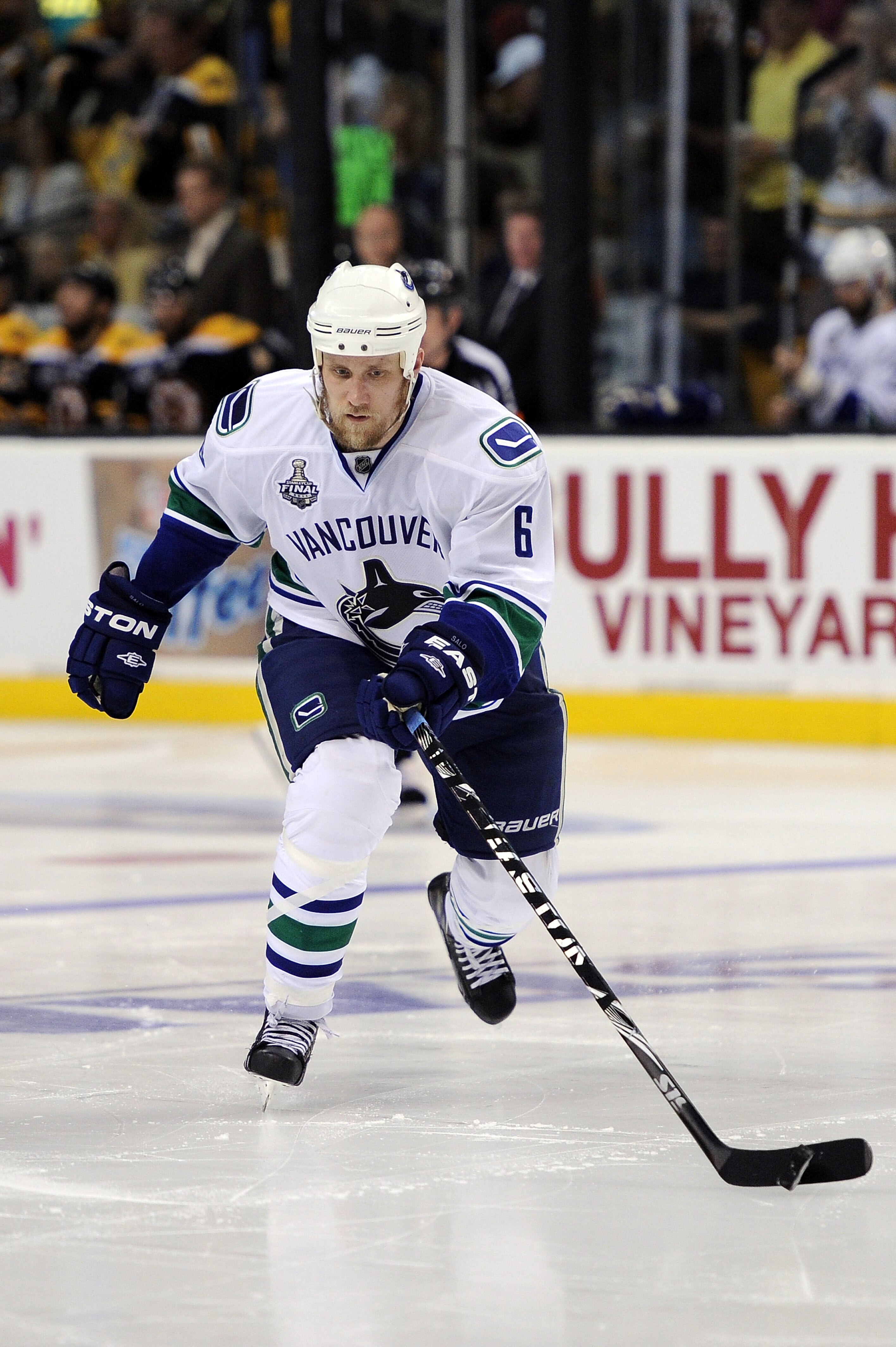 BOSTON, MA - JUNE 08:  Sami Salo #6 of the Vancouver Canucks skates with the puck against the Boston Bruins during Game Four of the 2011 NHL Stanley Cup Final at TD Garden on June 8, 2011 in Boston, Massachusetts.  (Photo by Harry How/Getty Images)