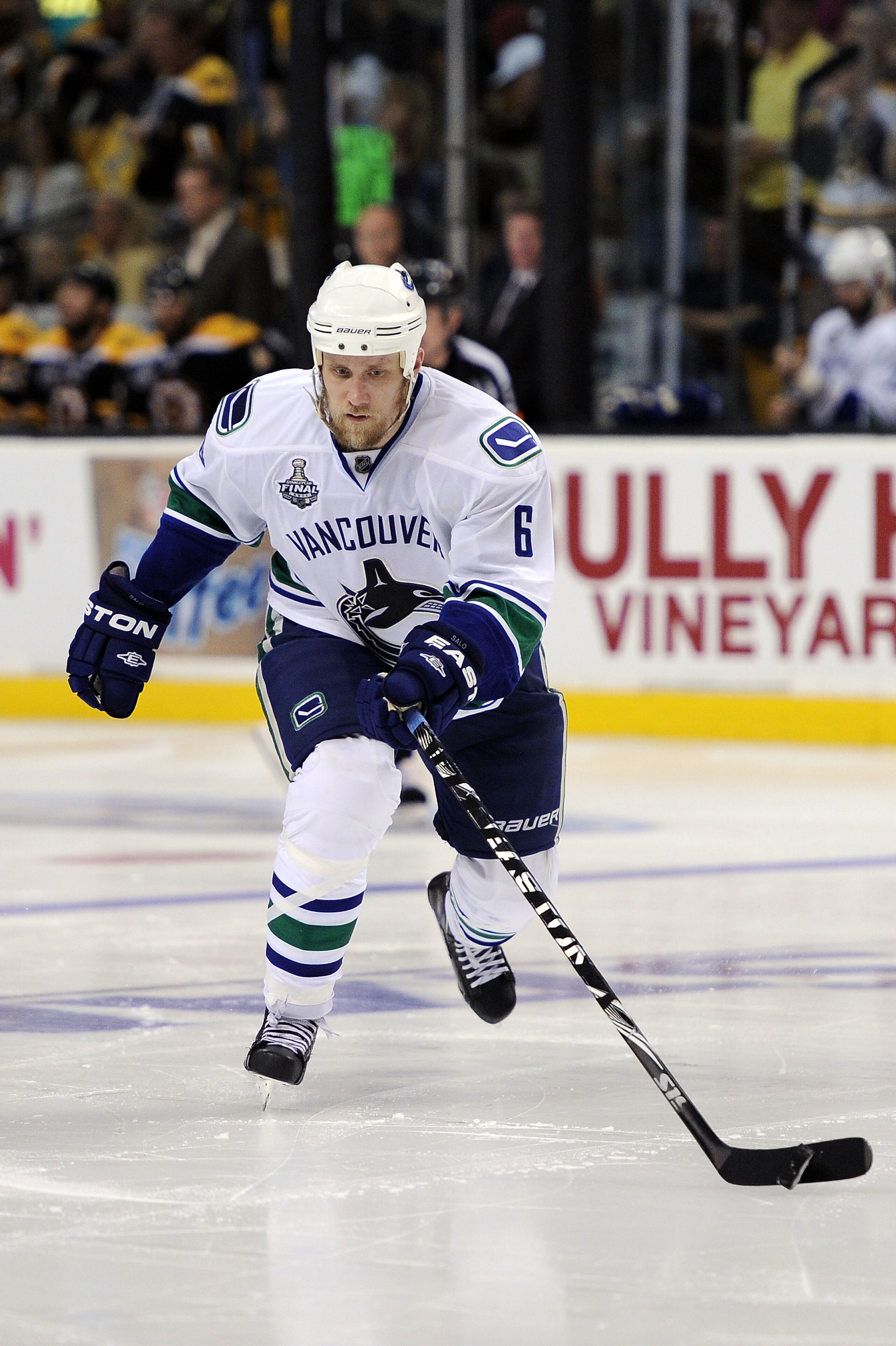 BOSTON, MA - JUNE 08:  Sami Salo #6 of the Vancouver Canucks skates with the puck against the Boston Bruins during Game Four of the 2011 NHL Stanley Cup Final at TD Garden on June 8, 2011 in Boston, Massachusetts.  (Photo by Harry How/Getty Images)