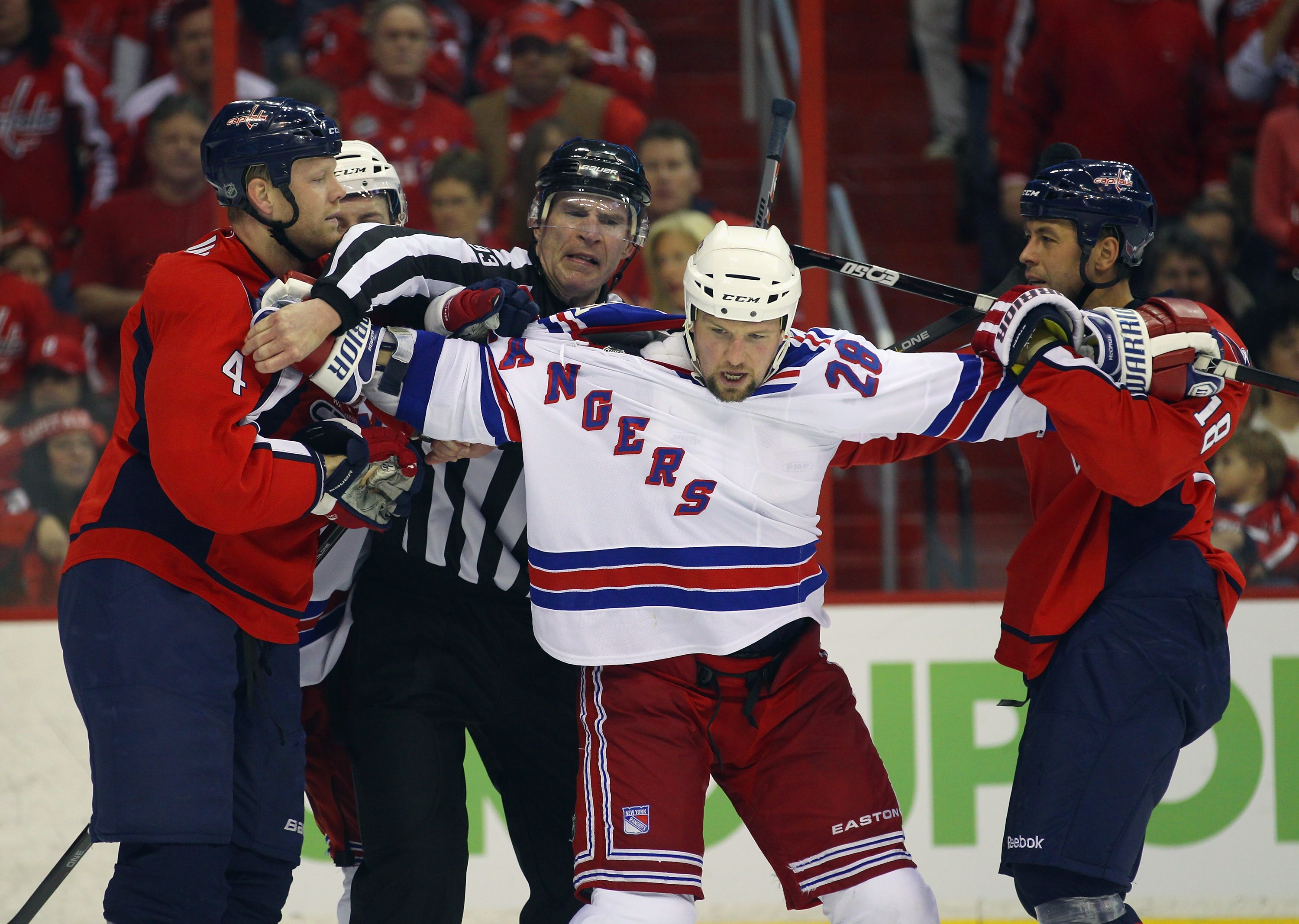 WASHINGTON, DC - APRIL 15: Bryan McCabe #28 of the New York Rangers holds off John Erskine #4 (L) and Marco Sturm #18 (R) of the Washington Capitals in Game Two of the Eastern Conference Quarterfinals during the 2011 NHL Stanley Cup Playoffs at Verizon Ce